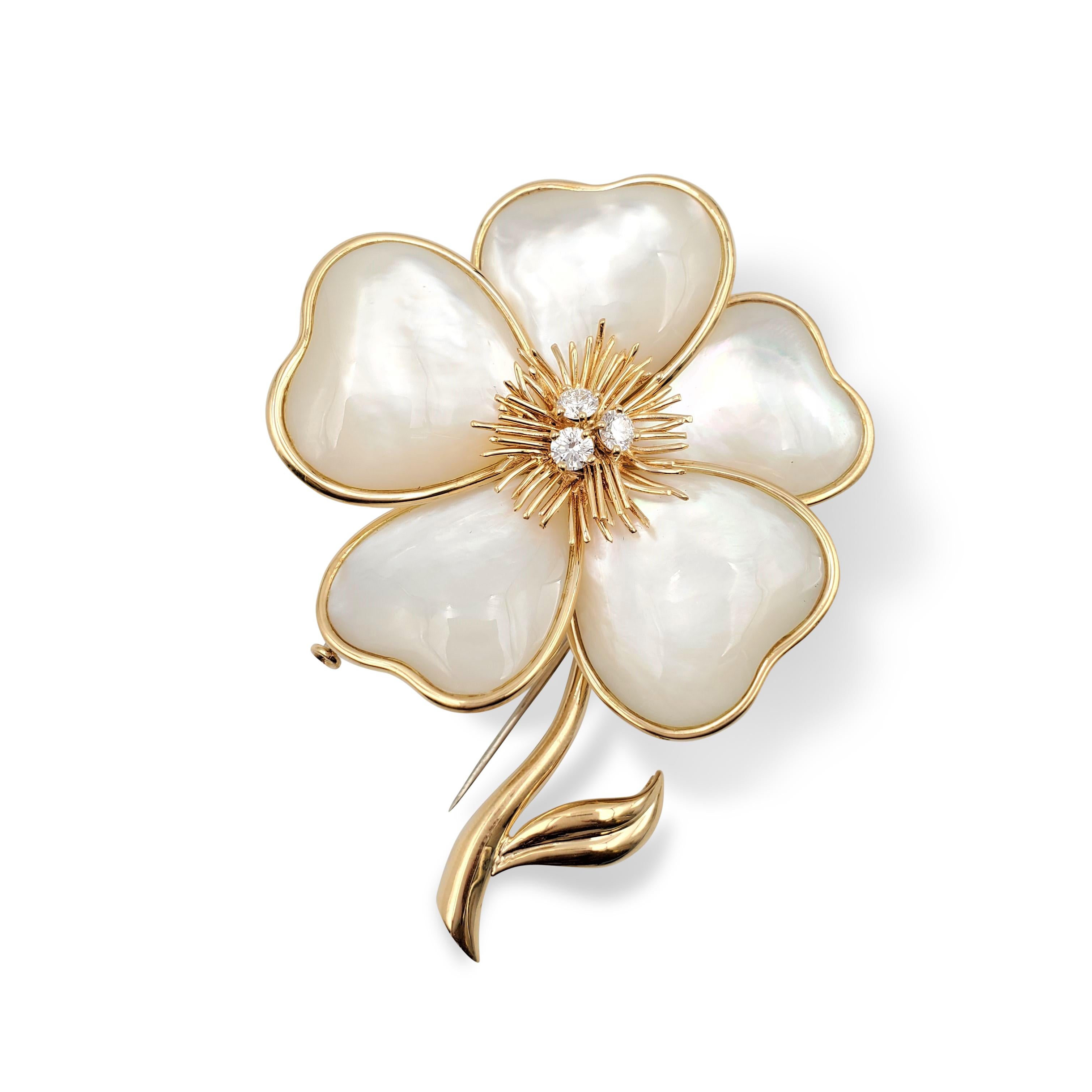 Authentic Van Cleef & Arpels Clématite pin designed as a clematis flower highlighted with round brilliant-cut diamonds (E-F color, VS clarity) weighing an estimated 0.60 carats on spiked gold filaments. The mother-of-pearl segments of flower petals