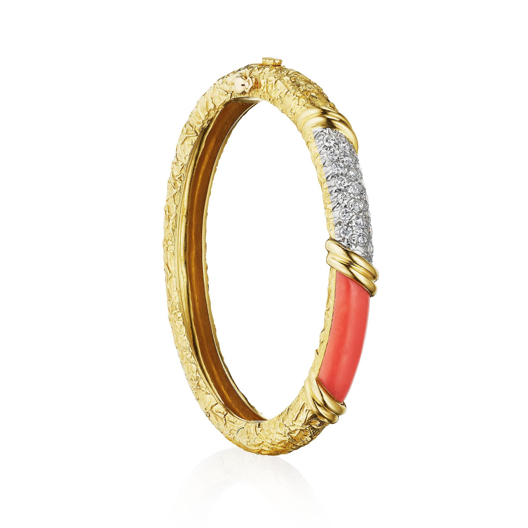 Van Cleef & Arpels Coral and Diamond Bangle Bracelet
Designed by Van Cleef & Arpels, Paris, this 18K gold and diamond bangle bracelet dates from circa 1970. The hinged bombé form is set with a field of pavé-set round brilliant-cut diamonds and an