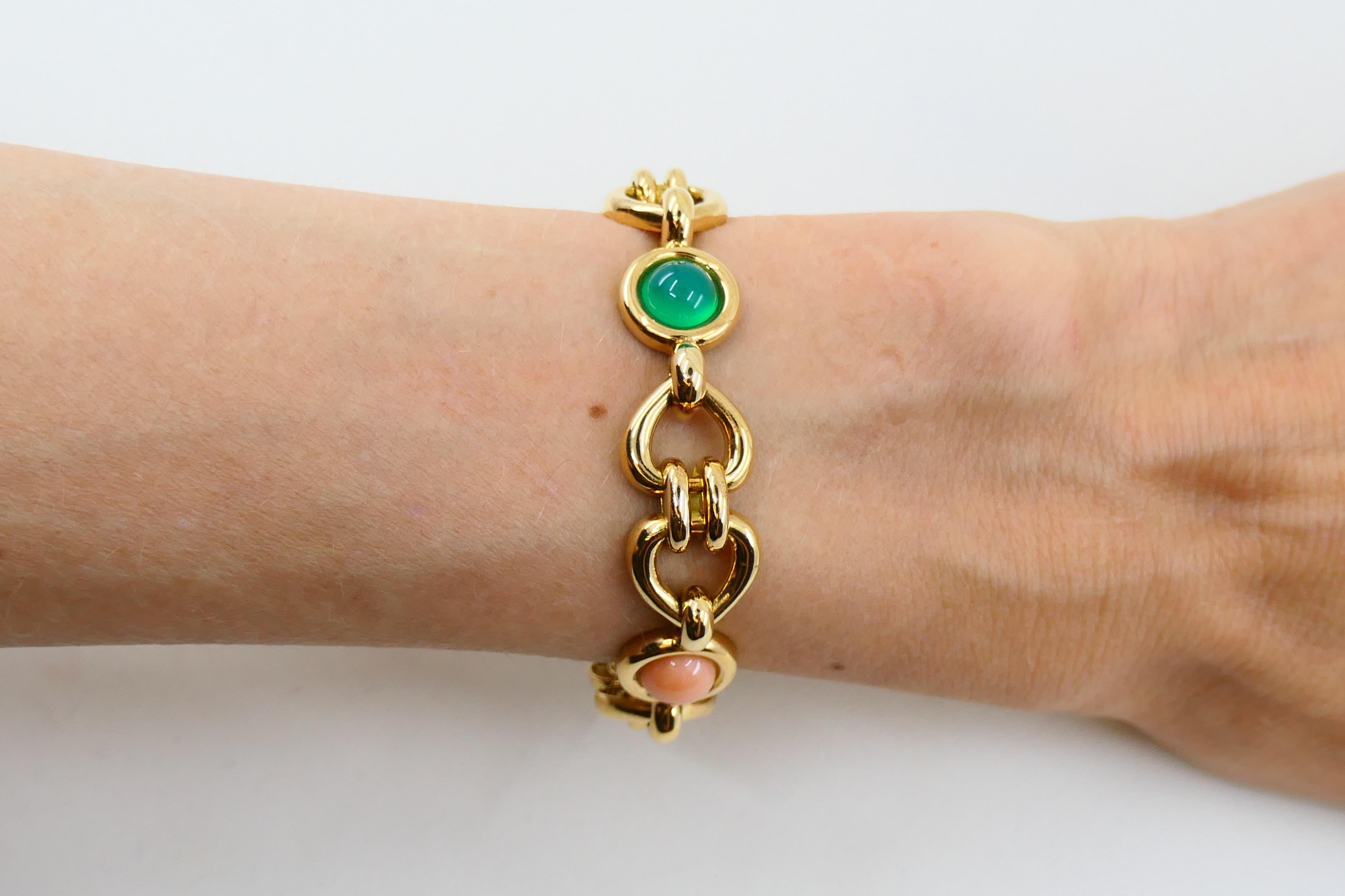 A beautiful vintage bracelet by Van Cleef & Arpels made of 18k gold, features corals and chrysoprase.
The bracelet is designed as heart-shaped links alternated with the cabochon corals and chrysoprares. Glossy polished gold links and candy-like gems