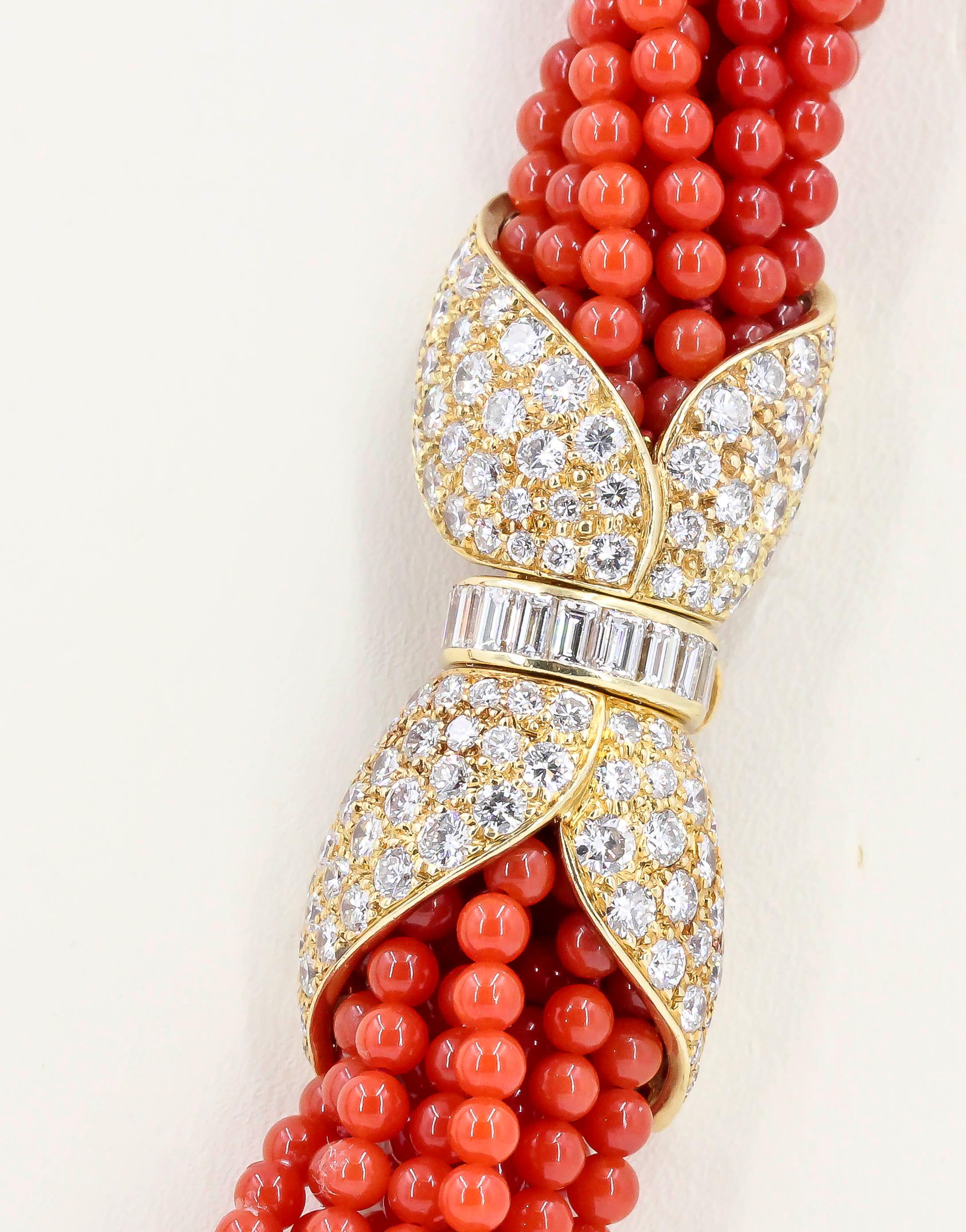 Chic diamond, coral and 18K yellow gold torsade necklace and bracelet combination by Van Cleef & Arpels, circa 1970-80s. It features 8 strands of rich red coral beads, held on by two clasps (each of which completes the necklace and the bracelet, or