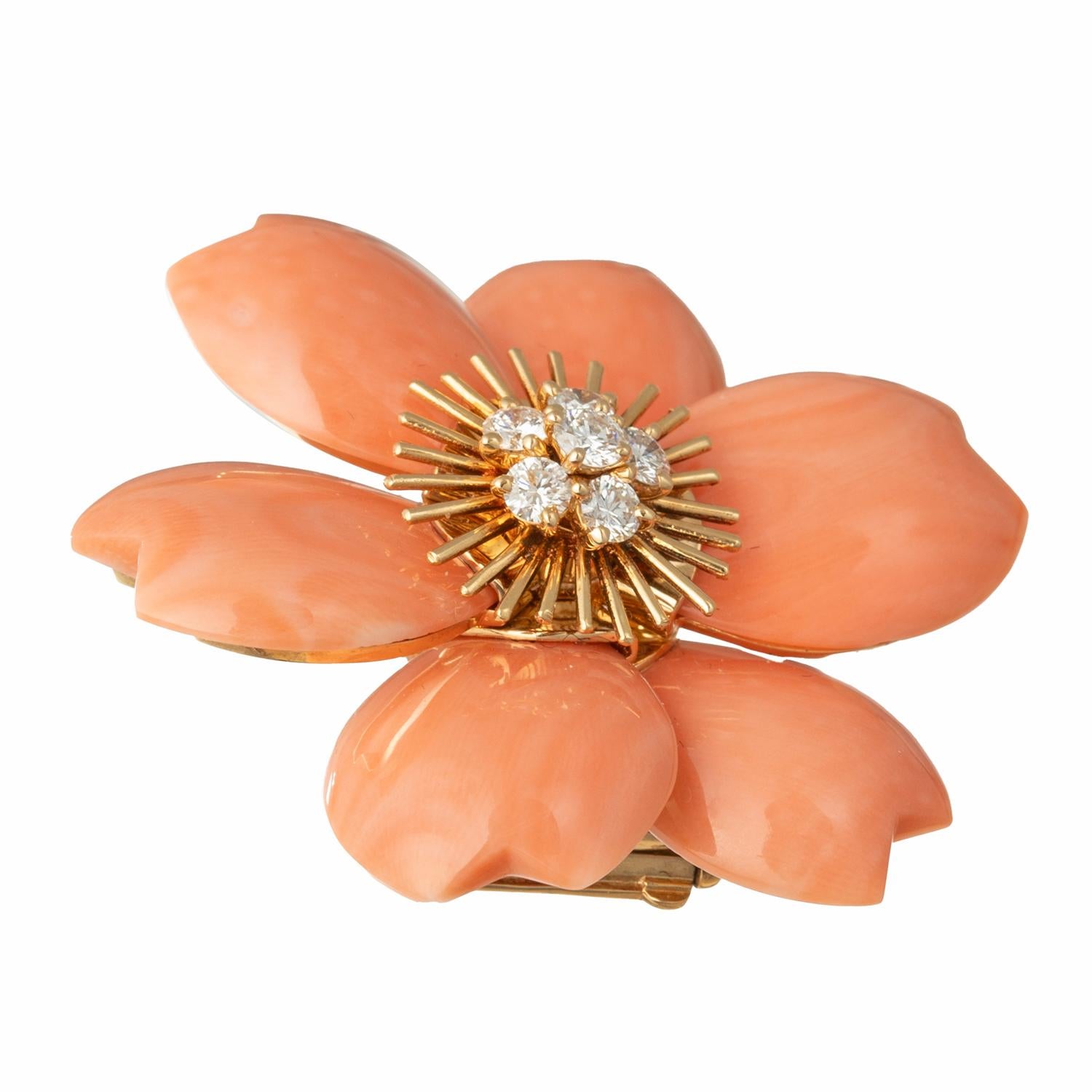 The medium-sized version of the 'Rose de Noel' brooch by Van Cleef & Arpels in 18k yellow gold, featuring carved salmon-toned coral petals centering a cluster of round brilliant-cut diamonds.  Six diamonds weighing approximately 0.60 carats (E-F