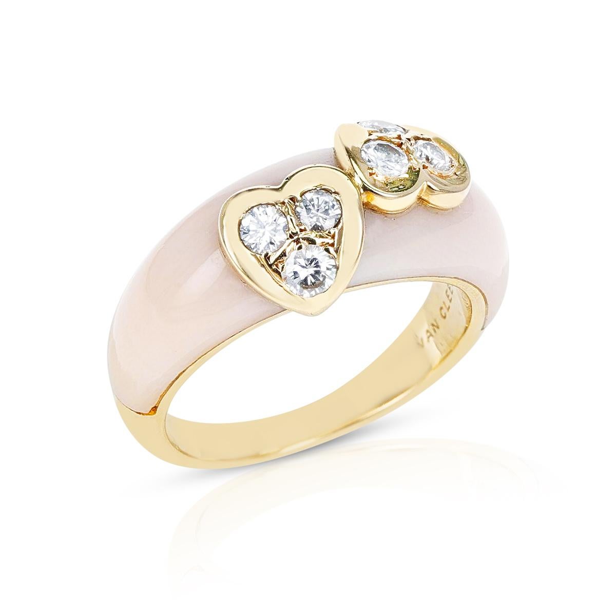 A chic Van Cleef & Arpels Coral Double Heart with Diamonds Ring made in 18 Karat Yellow Gold. The ring size is US 4.50. The total weight of the ring is 5.08 grams. 
SKU 24