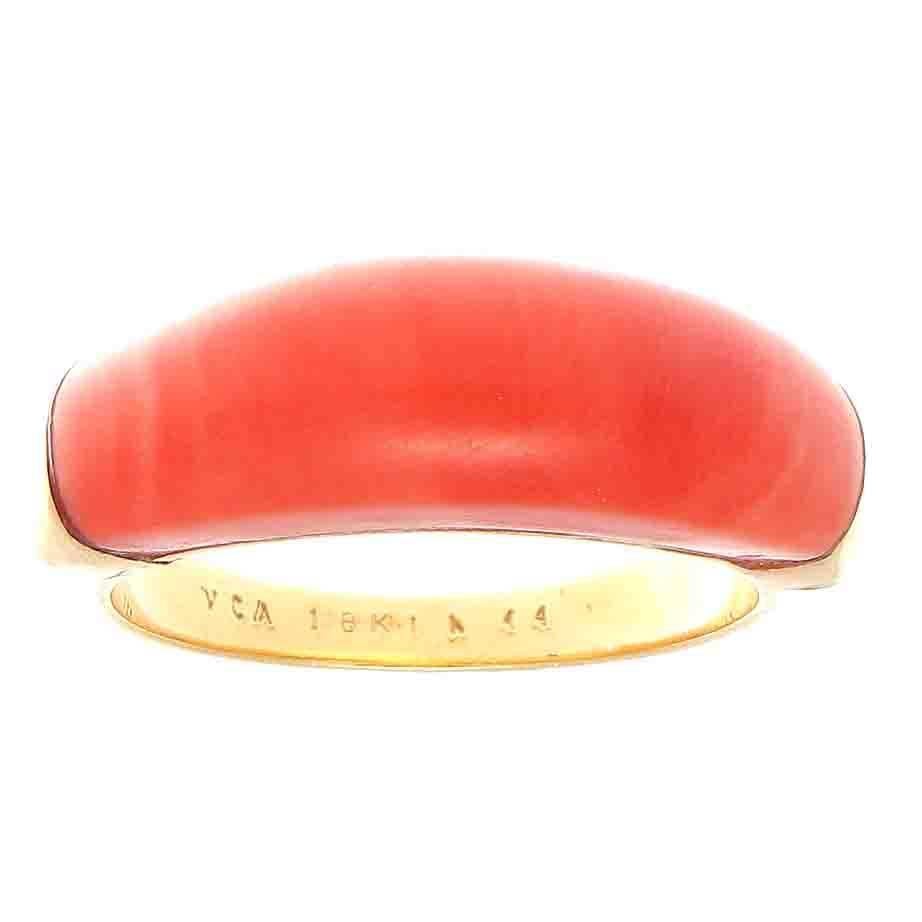 From Van Cleef & Arpels, a spare and lovely designed ring with radiant orangish-red coral. Hand crafted in glistening 18k yellow gold. Signed VCA, numbered and stamped with French hallmarks. Contact us if you are interested in purchasing the