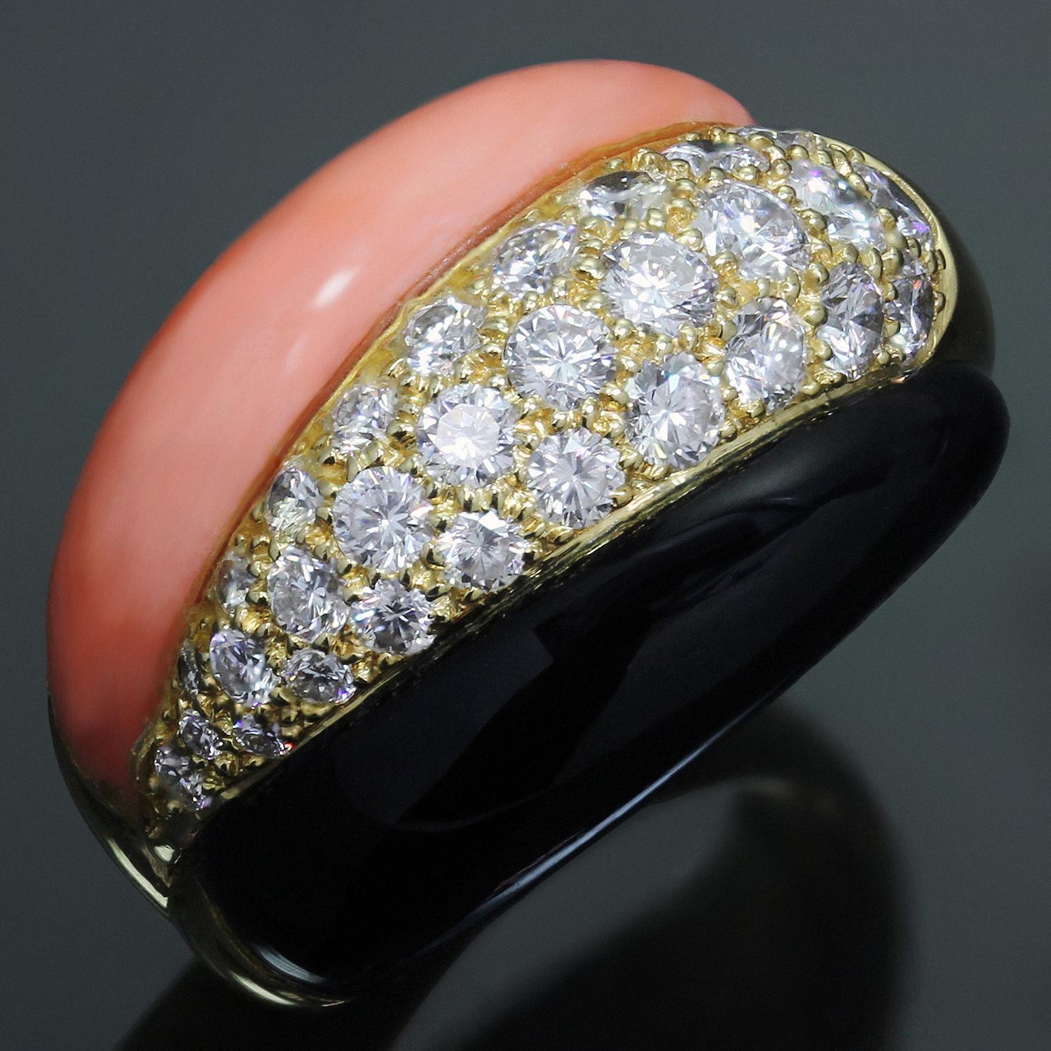 This gorgeous and rare Van Cleef & Arpels ring is crafted in 18k yellow gold, inlaid with coral and onyx and pave-set with round brilliant F-G VVS2-VS1 diamonds weighing an estimated 0.40 carats. Made in France circa 1990s. Measurements: 0.59