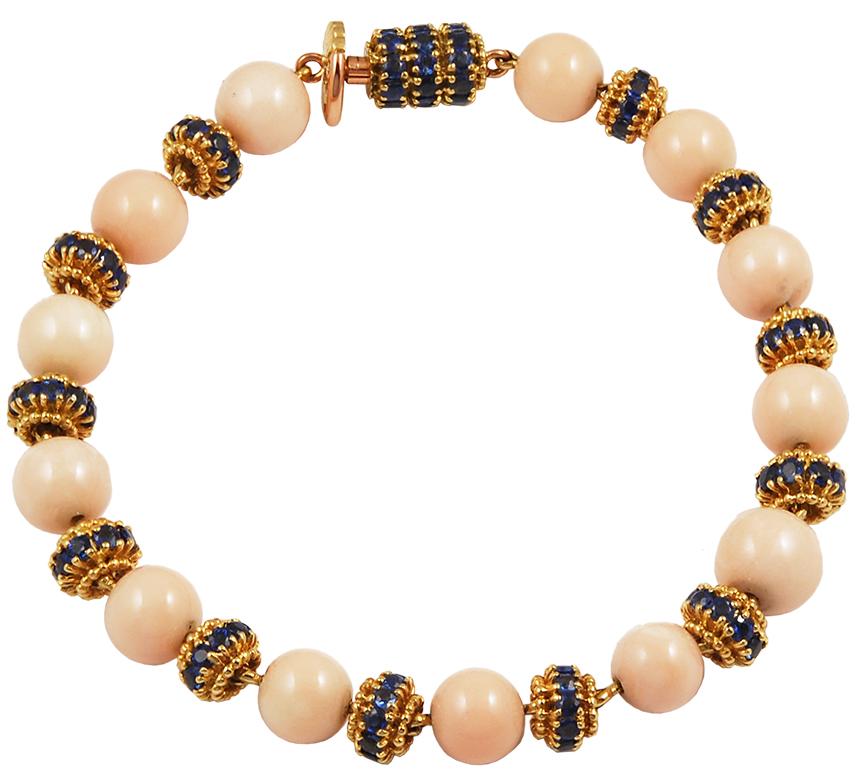 VAN CLEEF & ARPELS Coral Sapphire Convertible Necklace in 18k Yellow Gold.
Exceptionally crafted by Van Cleef & Arpels, this angel skin coral necklace is convertible and can be worn multiple ways: as a long Matinee necklace, a shorter