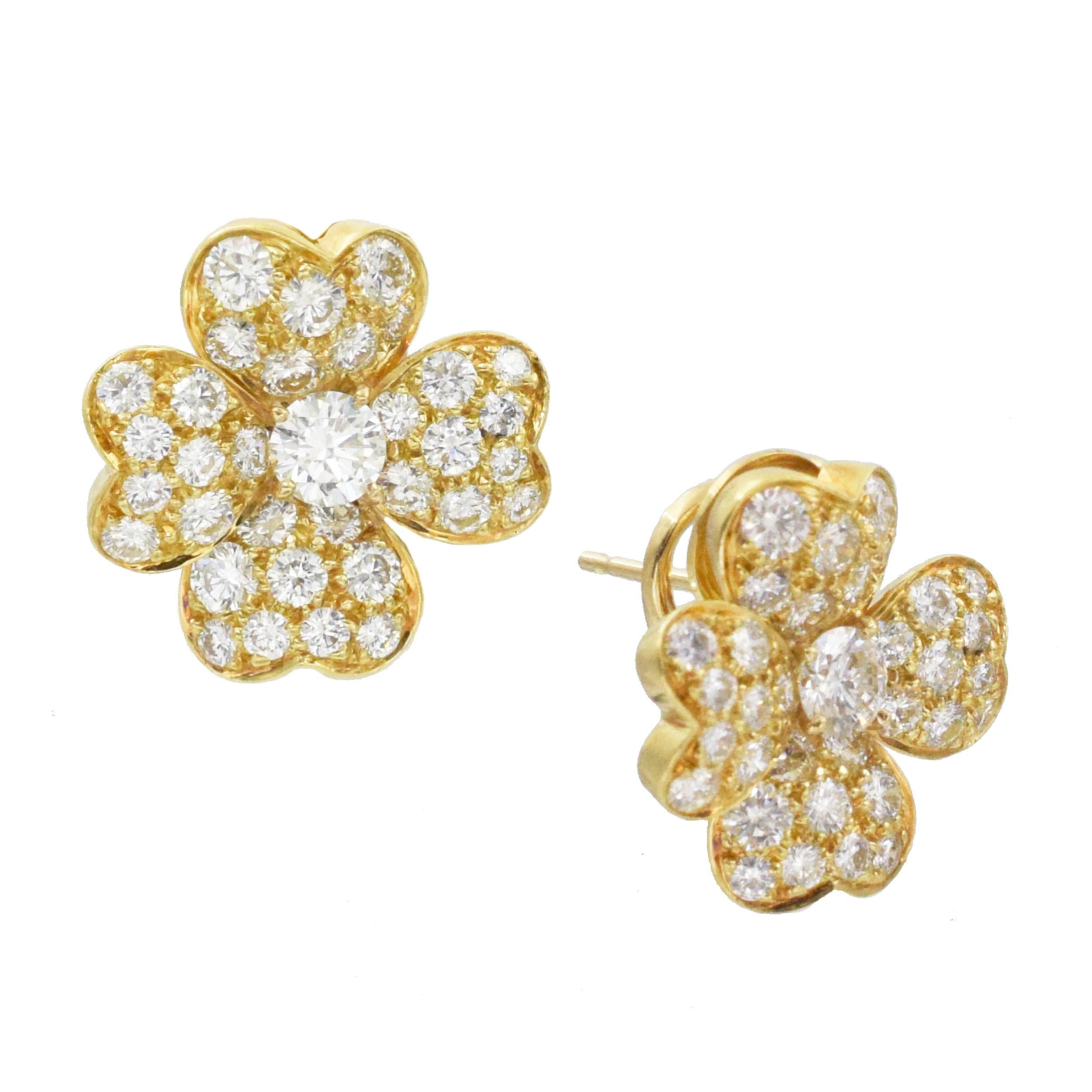 Van Cleef & Arpels 'Cosmos' Diamond and Gold Earrings. This pair of earrings has 2 clover motifs with round diamonds weight approximately 2.2ct (Color: E/F, Clarity: VS) all set in
18k yellow gold. The earrings has post with omega backs. Signed Van