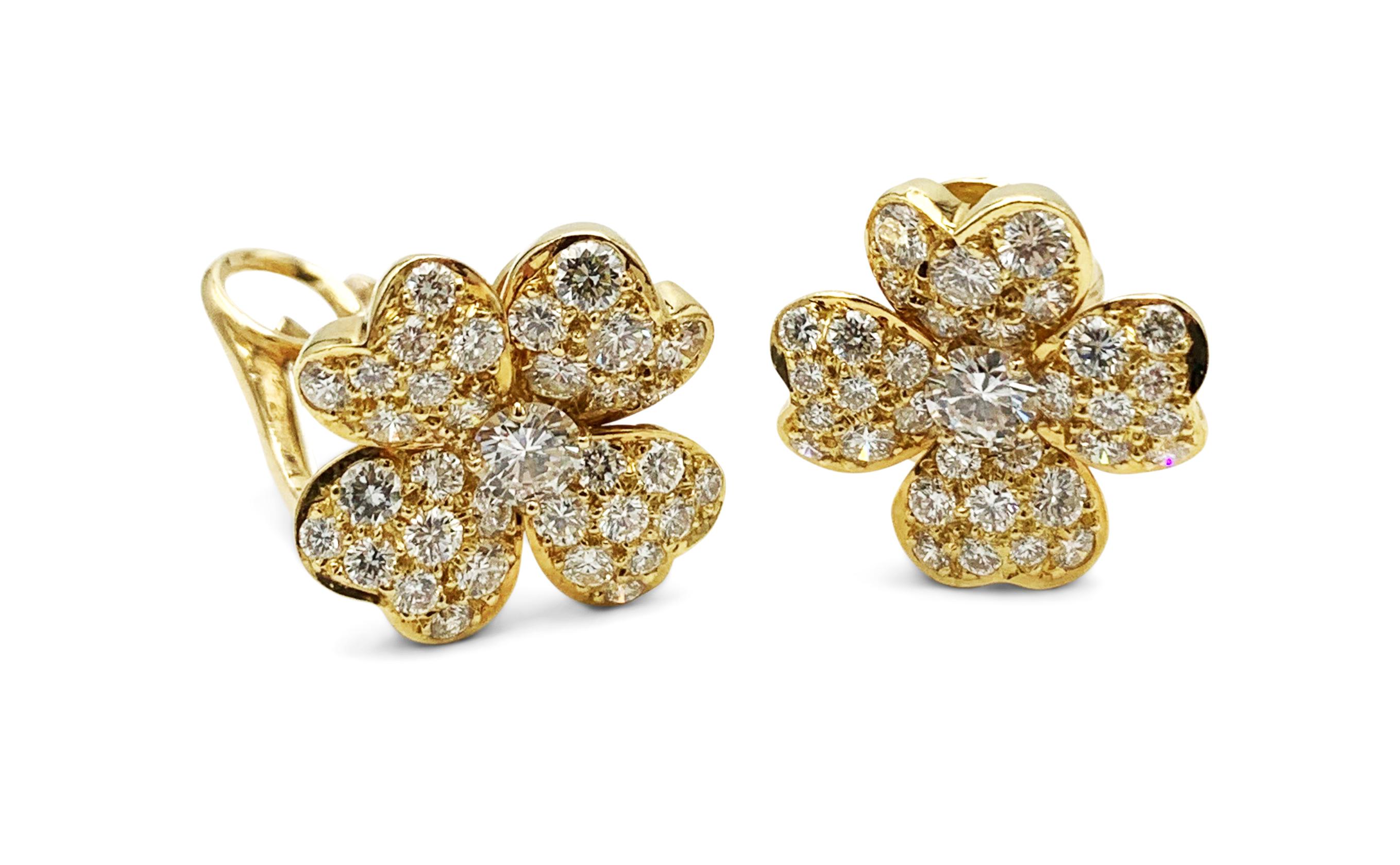 Authentic Van Cleef & Arpels 'Cosmos' earrings centering on a flower motif crafted in 18 karat yellow gold and set with high-quality round brilliant cut diamonds, weighing an estimated 2.00 cttw. Signed Van Cleef & Arpels NY, 750, with serial