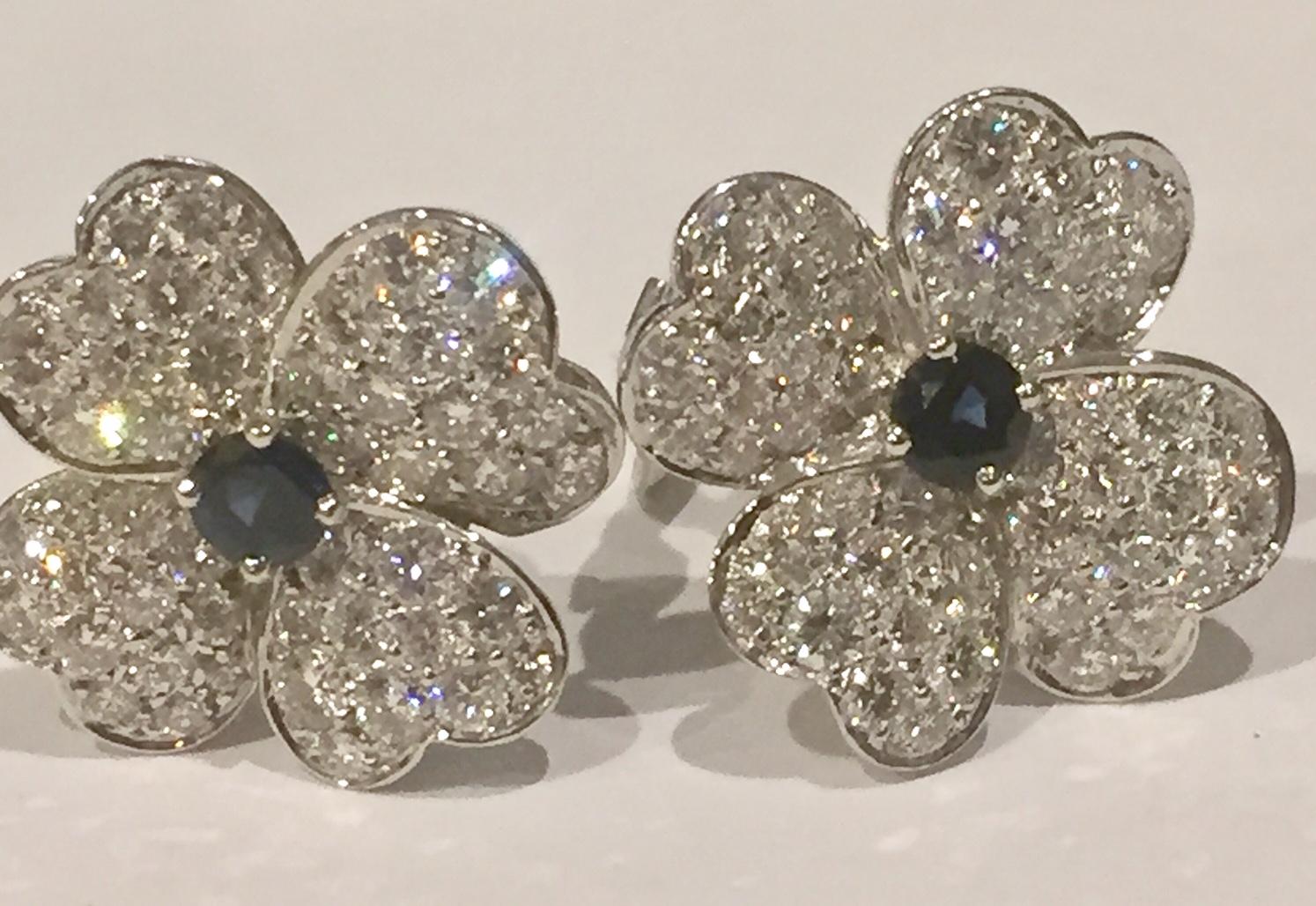 Very rare small model earrings from the cosmos collection by Van Clef & Arpels. Made in 18K yellow gold - white rhodium plated. Each flower-shaped earring features a prong-set faceted sapphire of around 0.45 ct. surrounded by  four petals pave-set