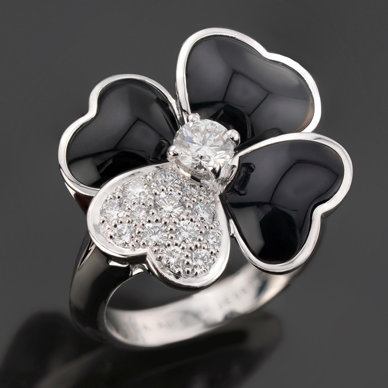 This gorgeous Van Cleef & Arpels ring from the enchanting Cosmos collection features a flower design crafted in 18k white gold and black onyx petals and set with round brilliant-cut E-F-G diamonds weighing an estimated 0.59 carats. Made in France