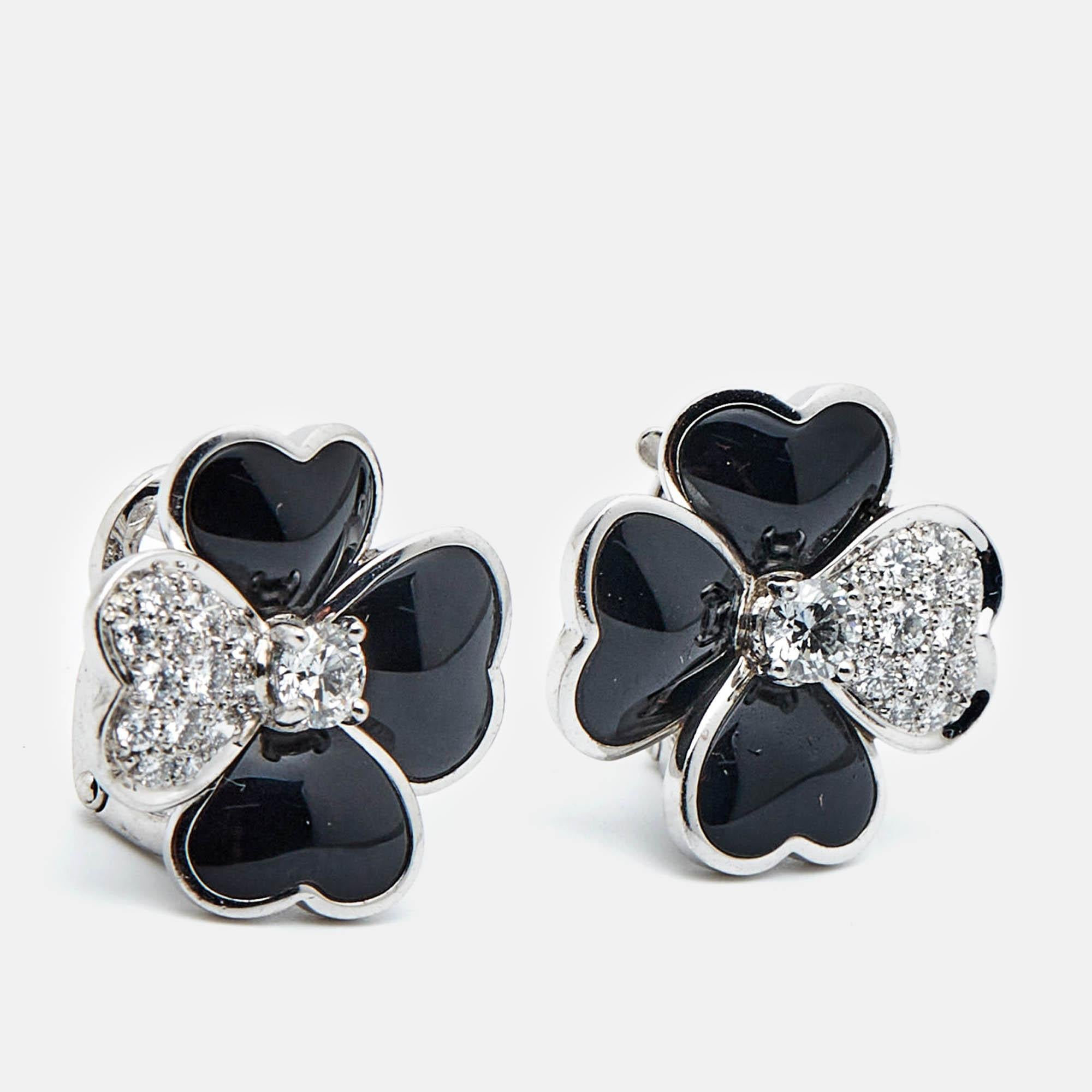 The Van Cleef and Arpels Cosmos earrings in 18k white gold are a breathtaking blend of elegance and nature inspired beauty. Featuring petals crafted from deep black onyx and adorned with sparkling diamonds these medium model earrings capture the