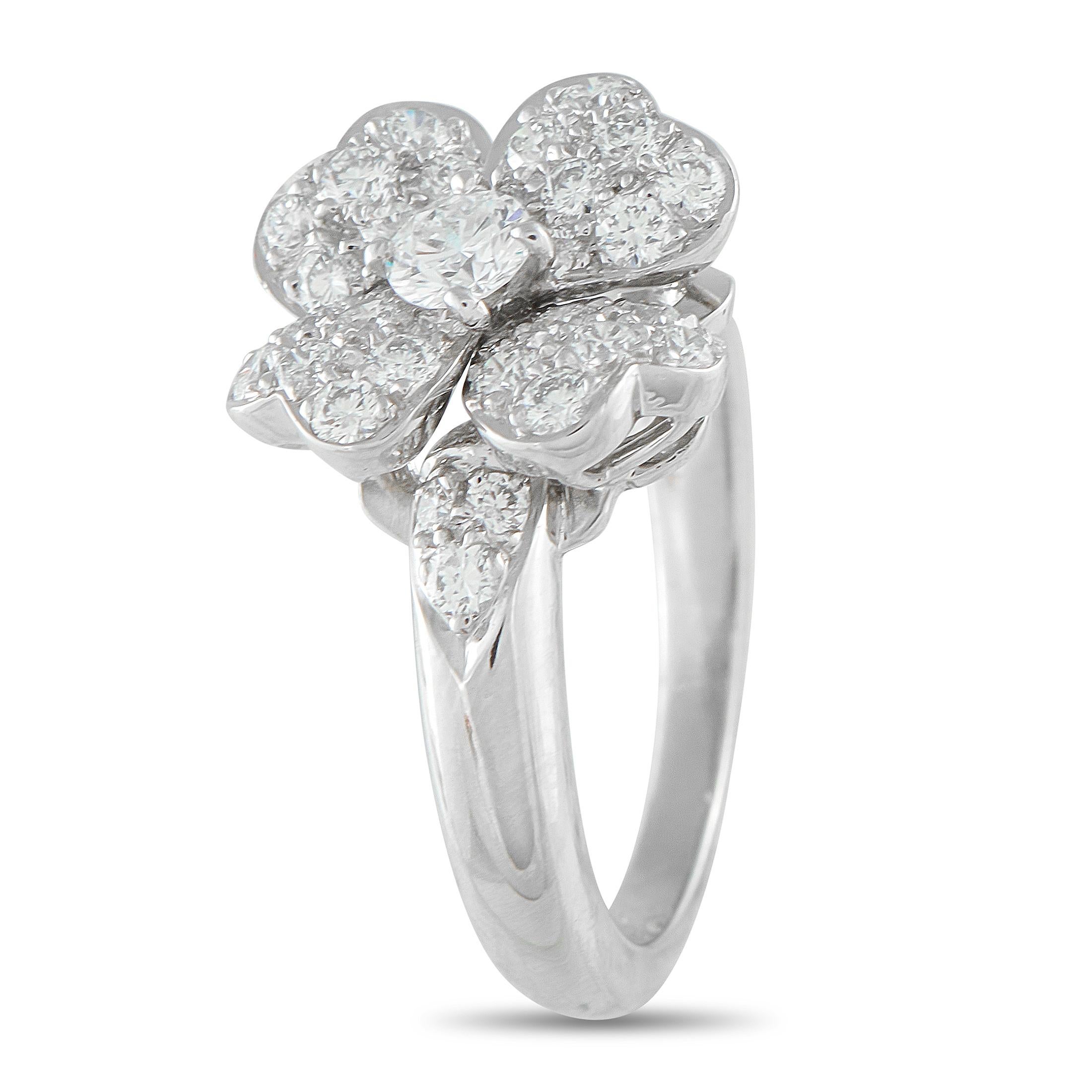 This Van Cleef & Arpels Cosmos ring is simply exquisite. On this impeccably crafted piece, four heart-shaped petals surround a sparkling center stone to create a timeless floral motif. Covered in Diamonds, the Platinum setting features a 2mm wide