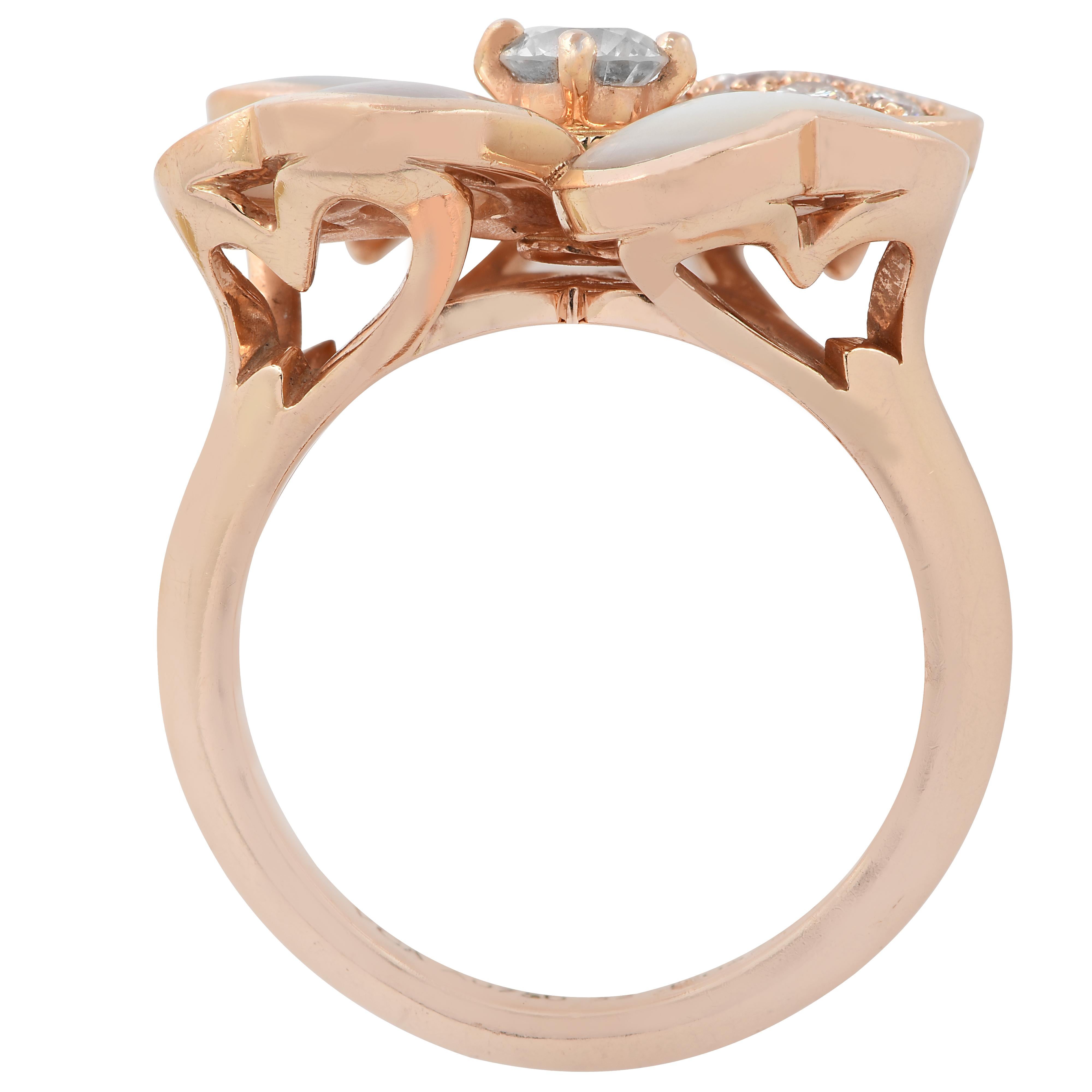 From the House of Van Cleef & Arpels, this exquisite Cosmos ring, is finely handmade in 18 karat rose gold. This stunning flower has three heart shaped petals with mother-of-pearl inlays, and one petal encrusted with 13 round brilliant cut diamonds