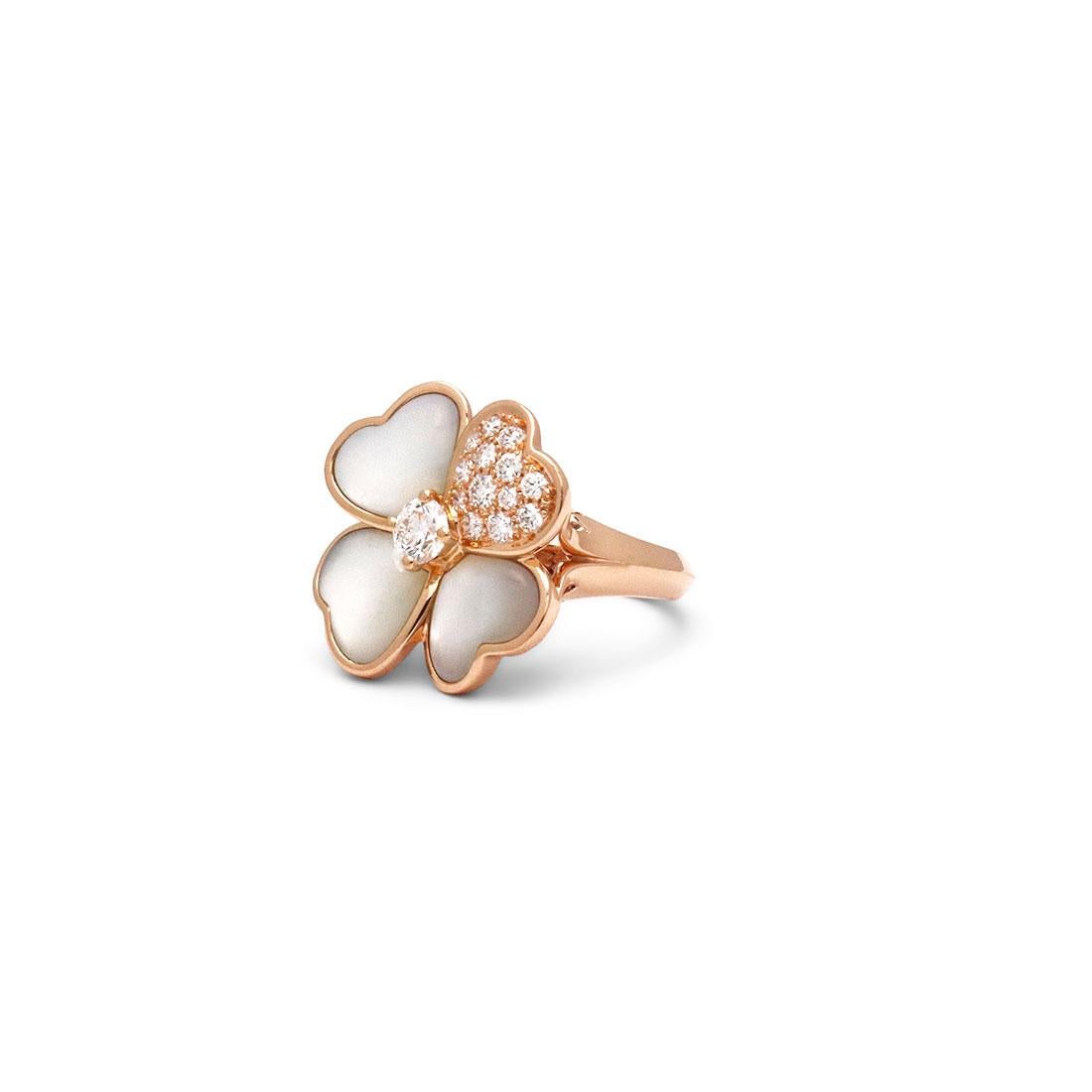 Authentic Van Cleef & Arpels Cosmos ring crafted in 18 karat rose gold is composed of four heart-shaped petals and a stunning centered diamond. Three of the petals are set with Mother-of-pearl stones while the fourth petal is set with 13 round