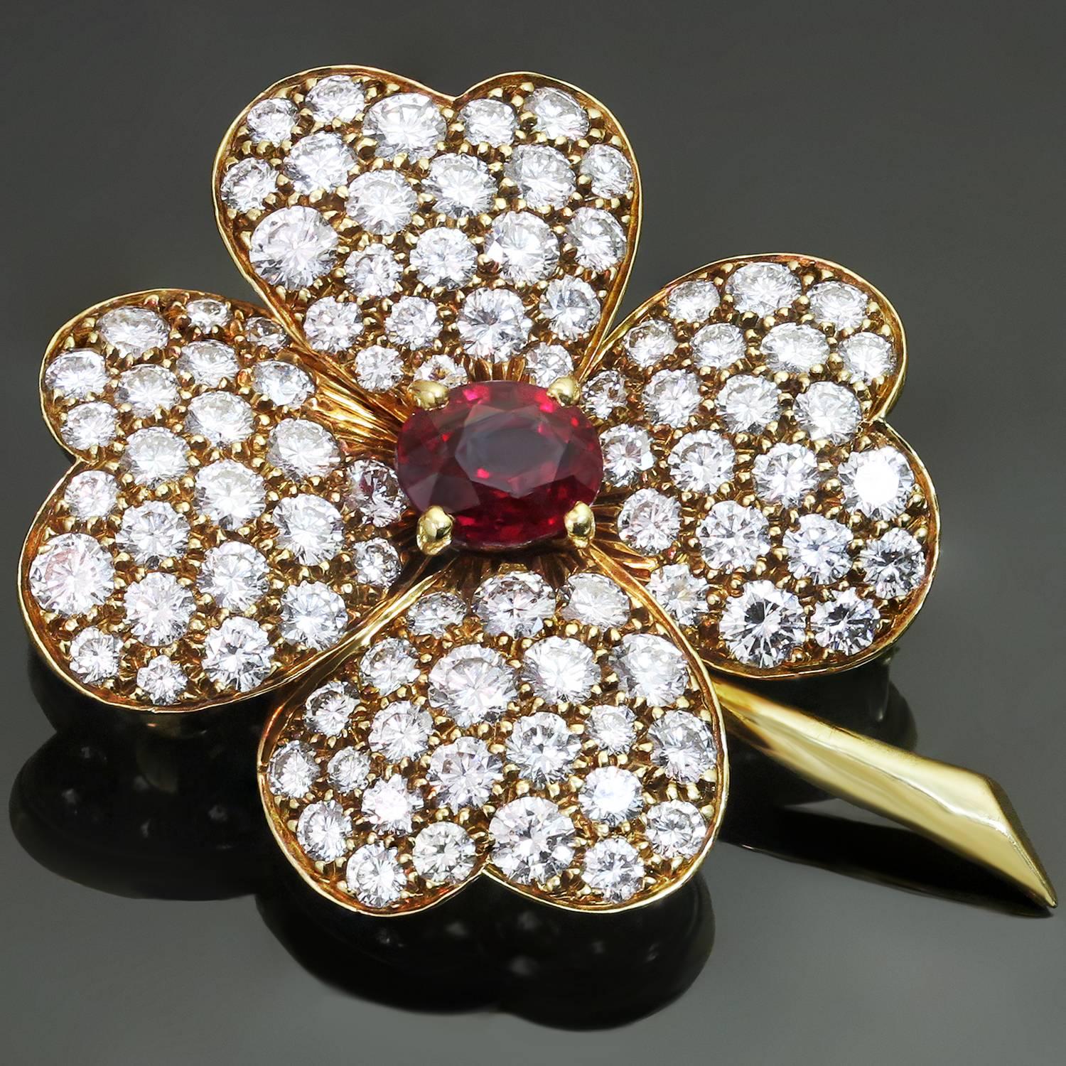 This iconic flower-shaped brooch from the radiant Cosmos collection by Van Cleef & Arpels  is crafted in 18k yellow gold and prong-set with a stunning 0.65 carat ruby in the center surrounded with four sparkling leaves pave-set with brilliant-cut