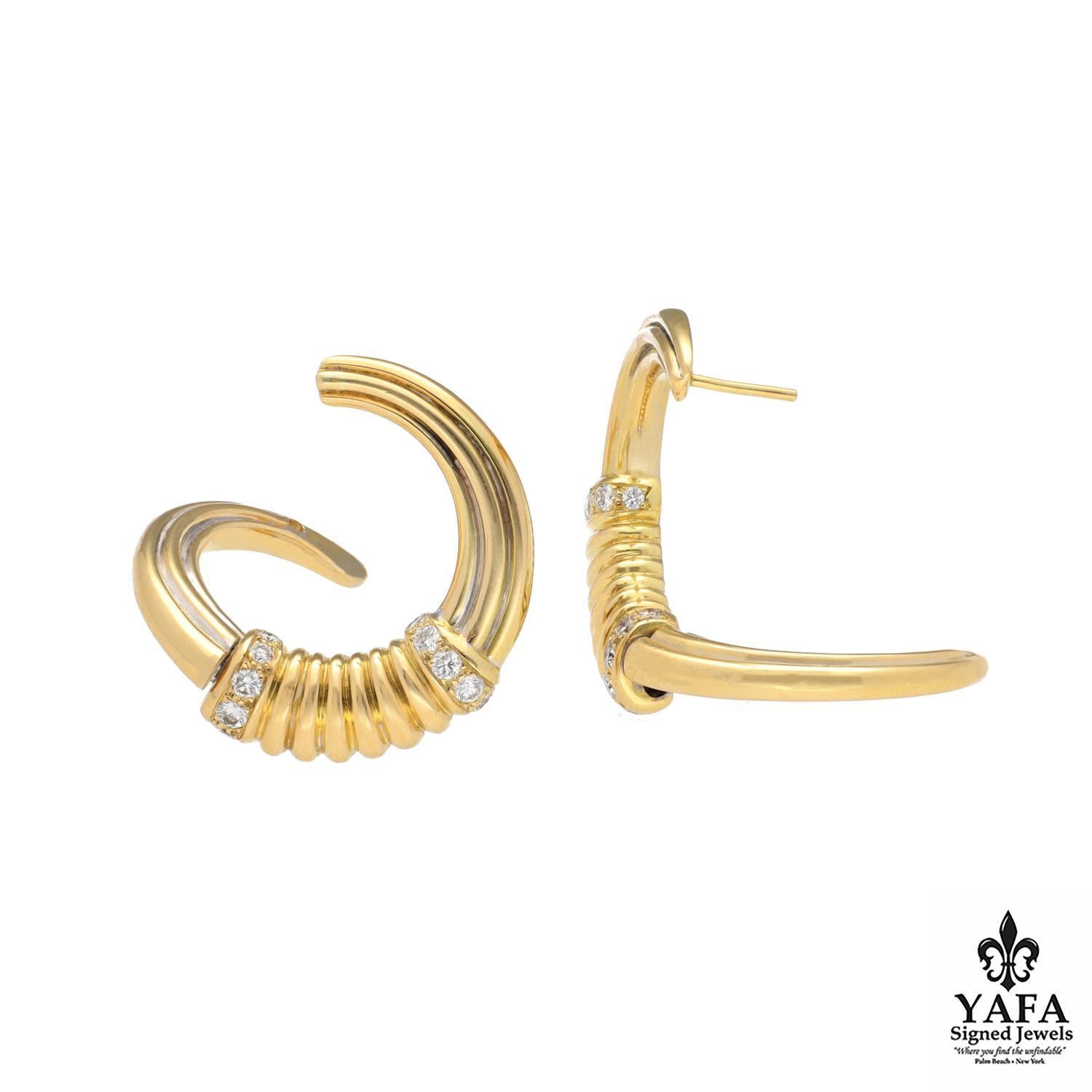 These exquisite 18-carat yellow gold hoop earrings embody the brand's timeless elegance and exceptional craftsmanship. The refined design features a delicately textured band adorned with sparkling diamonds, adding a luxurious touch and brilliance to