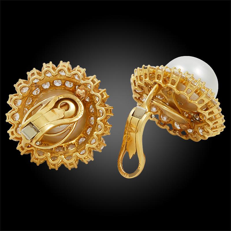 A pair of 18k yellow gold earrings, set with brilliant-cut diamonds and cultured button-shaped pearl, signed Van Cleef & Arpels.

Total diamond carat weight approx. 13.0 cts. and pearl approx. 16.80mm