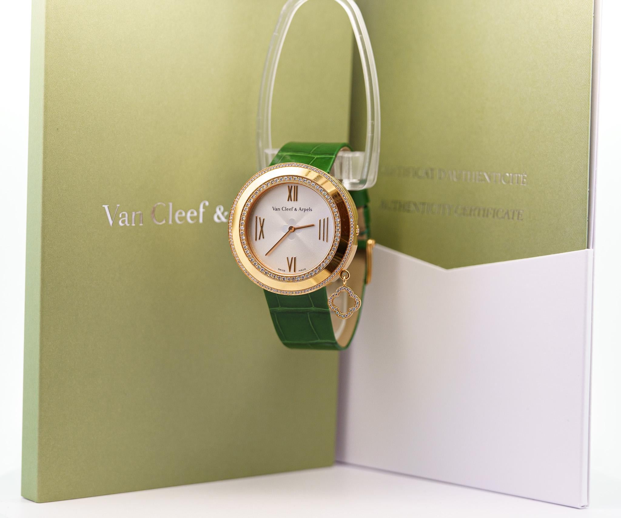 Van Cleef & Arpels Diamond Charms 38mm Women's Watch in 18K Rose Gold With Green Leather Strap. Complete with box and papers.

18k Rose gold case. Silver face, roman numeral hour markers. Adjustable alligator green leather band, tang clasp. Fixed