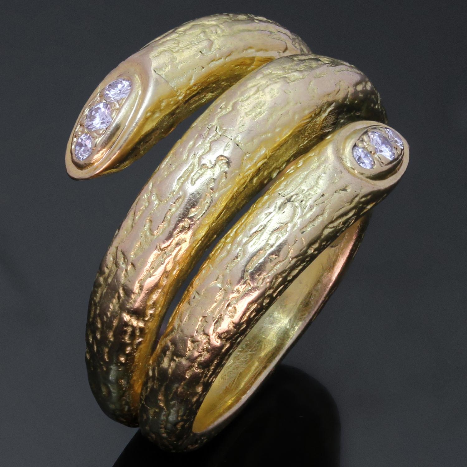 This gorgeous Van Cleef & Arpels ring features a coiled serpent design crafted out of 18k textured yellow gold set with a pair of round brilliant F-G-H VS1-VS2 diamonds weighing an estimated 0.10 carats. Made in France circa 1970s. Measurements: