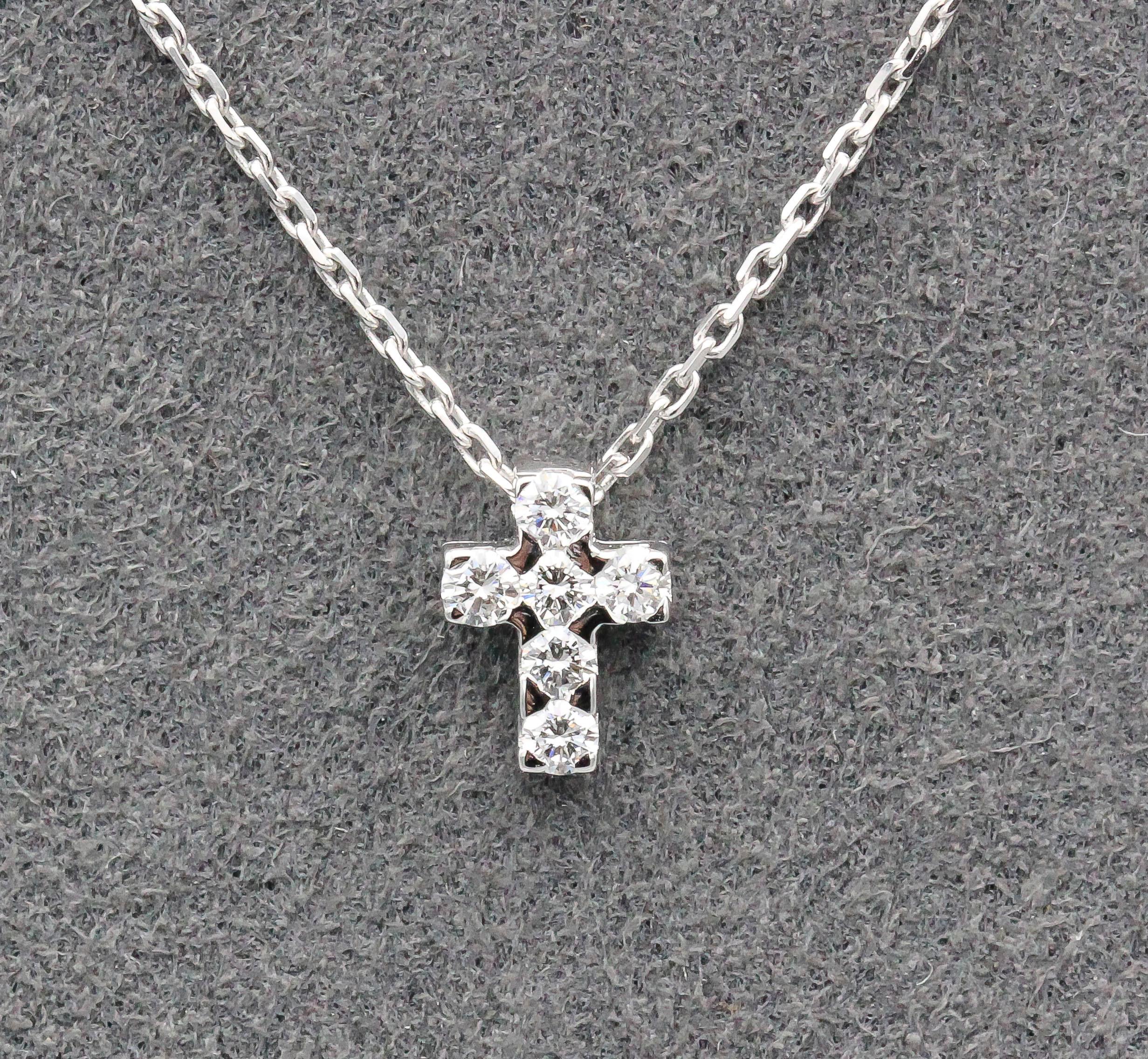 Fine diamond and 18K white gold cross pendant necklace by Van Cleef & Arpels. It is petite in size and unassuming, featuring high quality round diamonds.  Well made and easy to wear, a very fine gift idea.  Total length - 18