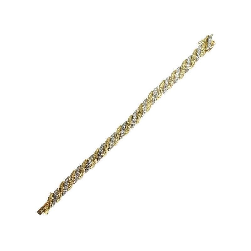 A vintage braided bracelet by Van Cleef & Arpels in 18 karat yellow gold and platinum, French control mark, signature Van Cleef & Arpels, engraved stock number of VCA 8961 CS, set with 105 brilliant cut diamonds totaling 6.30 carat. Dimensions: