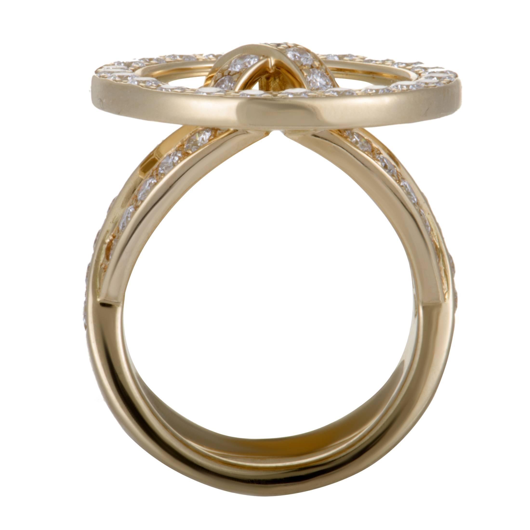 Impeccably crafted from radiant 18K yellow gold and designed in the form of a button, this splendid Van Cleef & Arpels ring boasts an exceptionally offbeat, fashionable appeal. The ring is set with resplendently colorless (grade D) diamonds of VVS