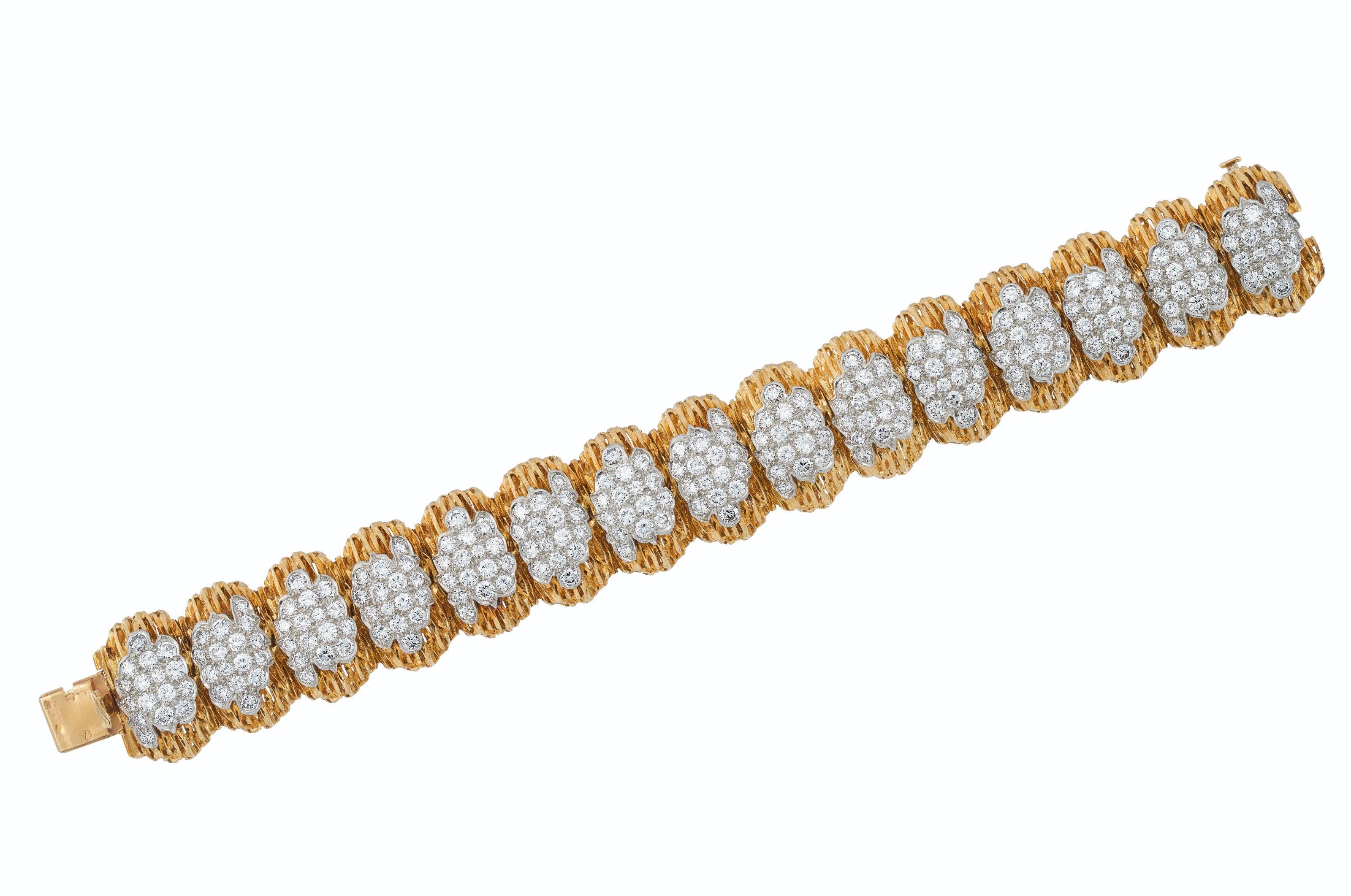 This Van Cleef & Arpels bracelet features 240 Round diamonds weighing approximately 9-10 carats, F-G color, VVS-VS. The textured 18k yellow gold and platinum with French marks is in very good overall condition showing normal signs of wear. Circa