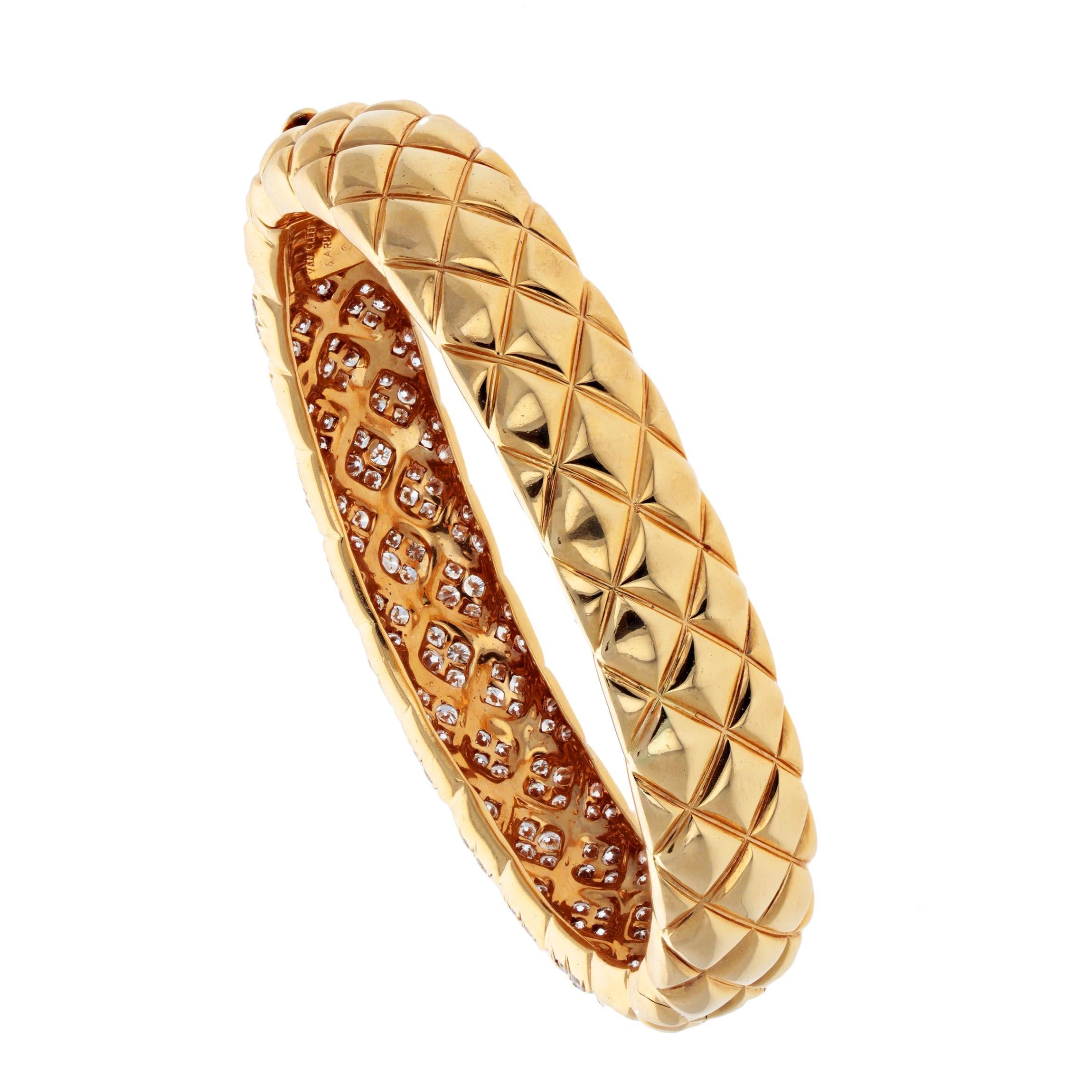 An easy-wearing bangle, cross-hatched to a cushion texture with the front half set with 178 round brilliant-cut diamonds in the Alhambra motif, at an estimated 4.8 carats, mounted in 18k yellow gold. Signed Van Cleef & Arpels with number M33955, 