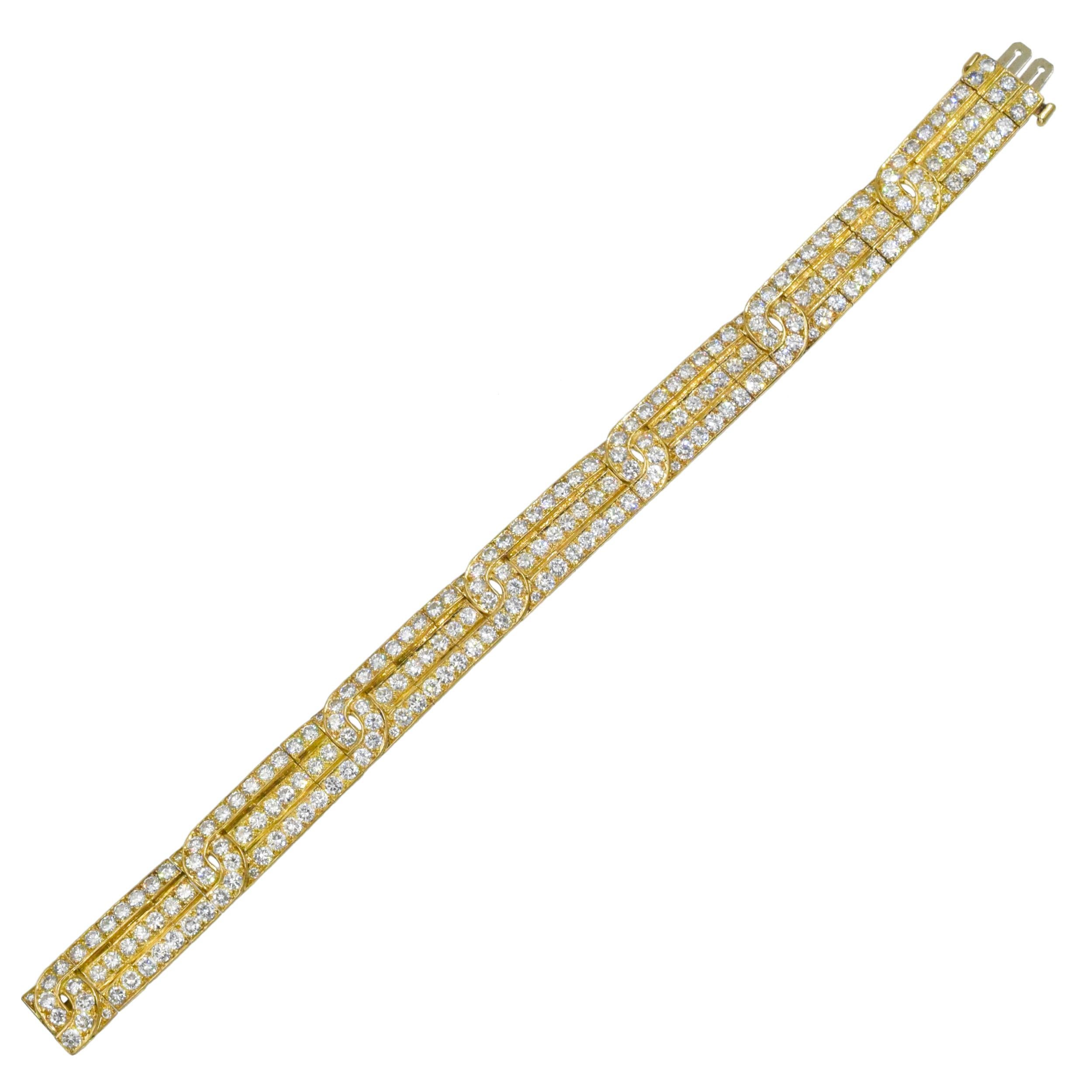 Van Cleef & Arpels Diamond and Gold Bracelet This bracelet is composed of three intertwined lines of
217 round diamonds weighing a total of approximately 12 carats (Color: F-G, Clarity: VS) all set in 18k yellow gold.
 Signed VCA Made In France,