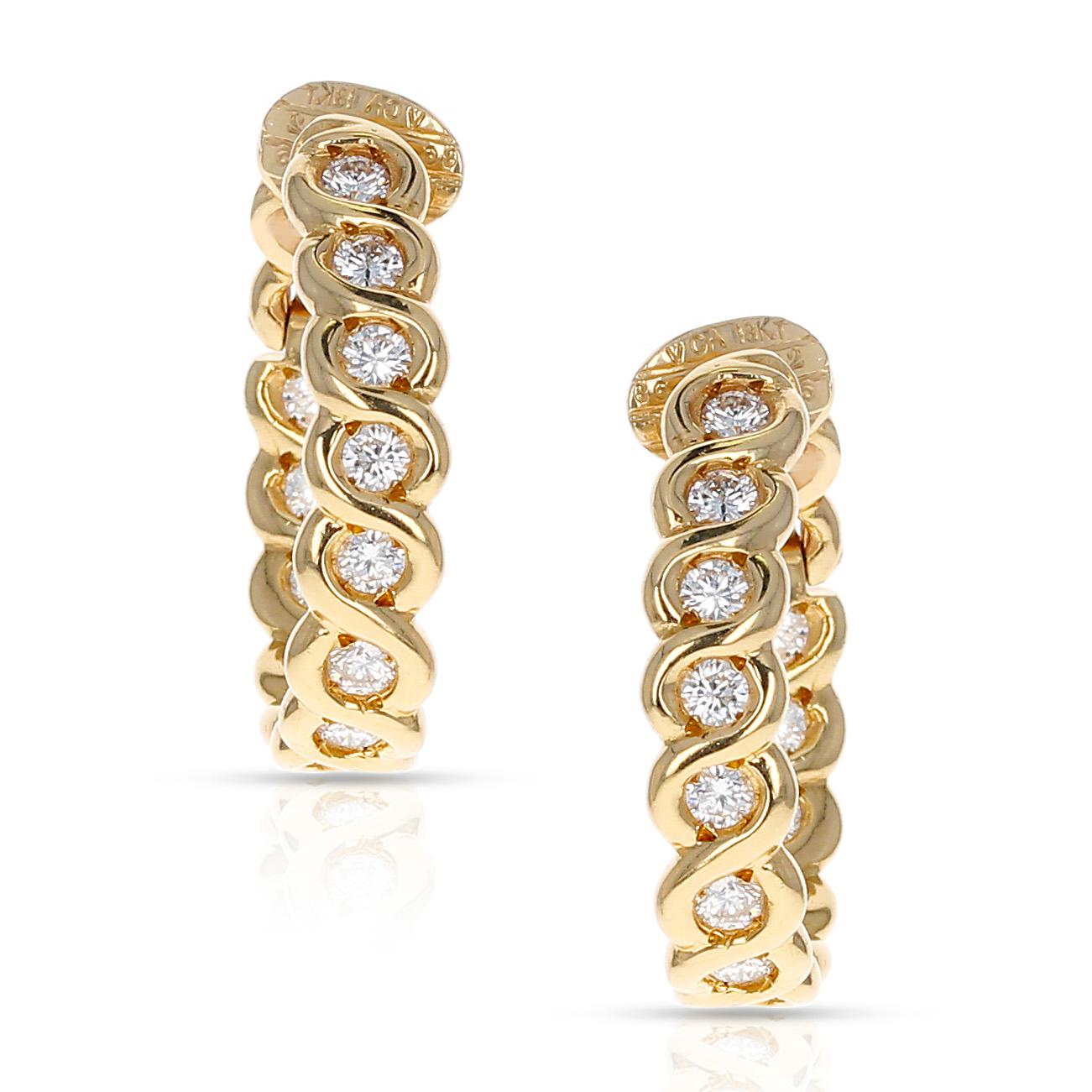 A beautiful and chic pair of yellow gold and diamond hoop earrings by Van Cleef and Arpels. The earrings have a total diamond weight of 1.82 carats and measure one-inch in length. The fine-quality twenty-six round brilliant-cut bezel-set diamonds