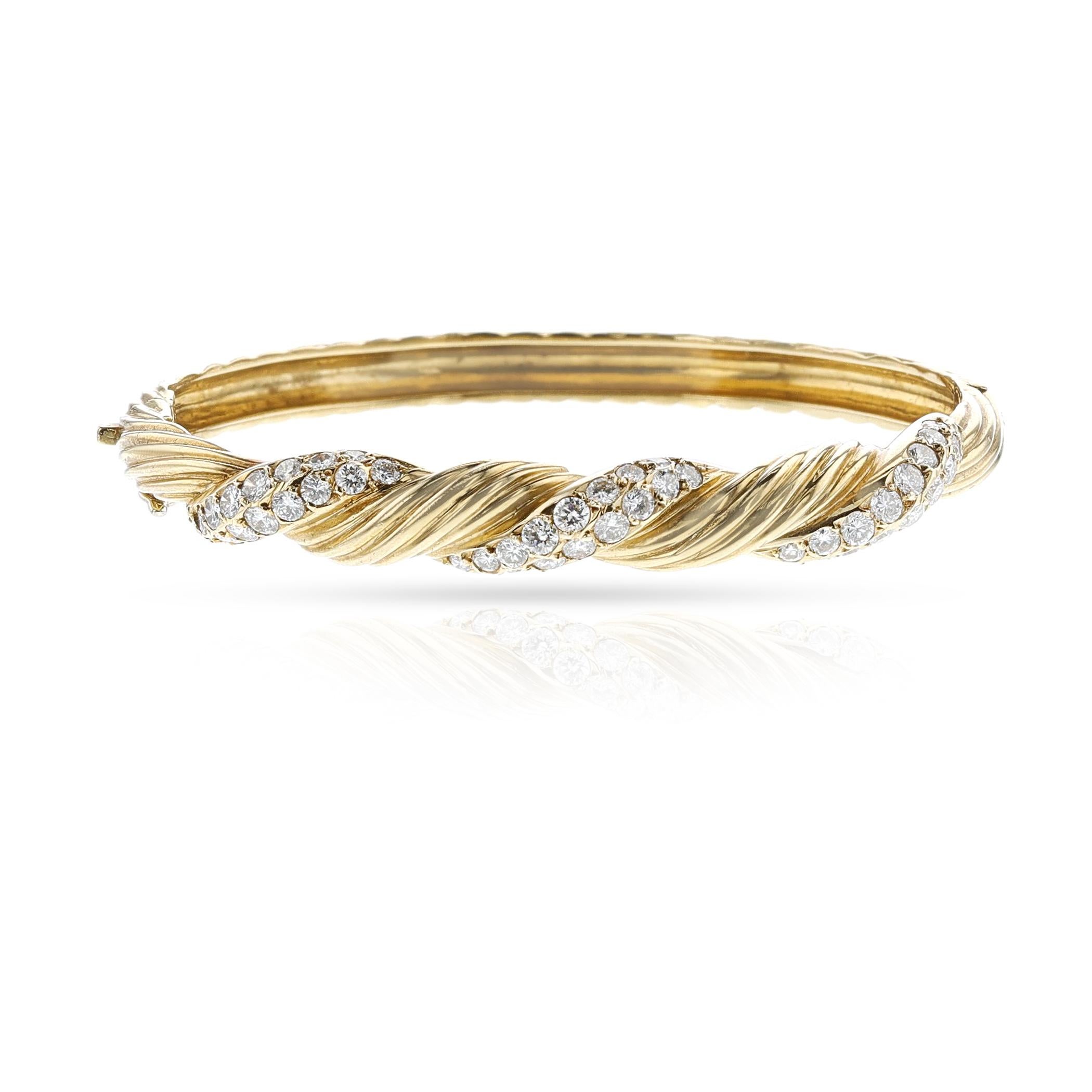 A Van Cleef & Arpels Diamond and Gold Bangle made in 18k Gold. The length is 6.3 inches. The weight of the bangle is 22.37 grams. Signed and numbered. Jeweler's Hallmark: Richard Wildenstein.

SKU: 1459-DAJATP