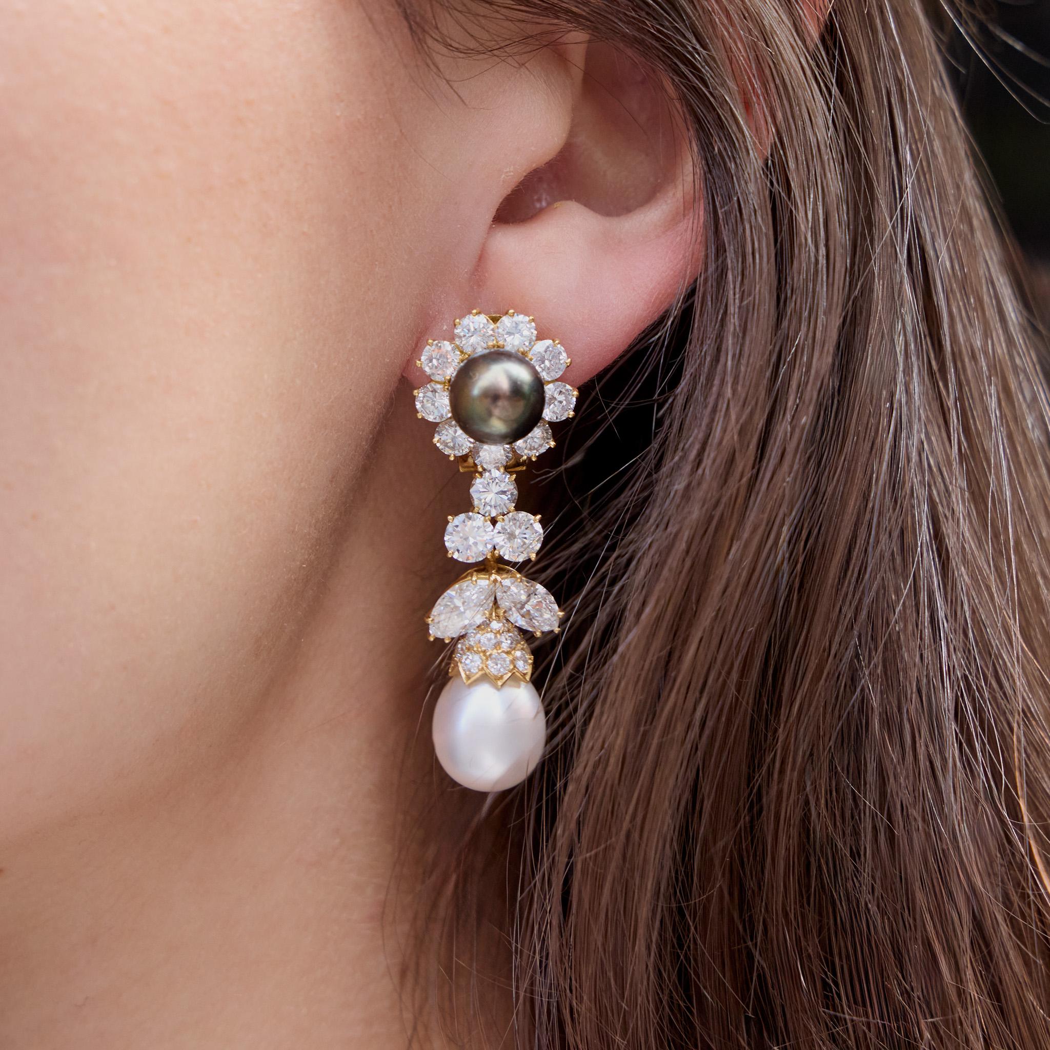 Dating from the 1980s, these Van Cleef & Arpels earrings are composed of Tahitian and South Sea pearls, 18K gold, and over 12 carats of diamonds. Each is designed as a Tahitian pearl with diamond surround suspending a cascade of round and