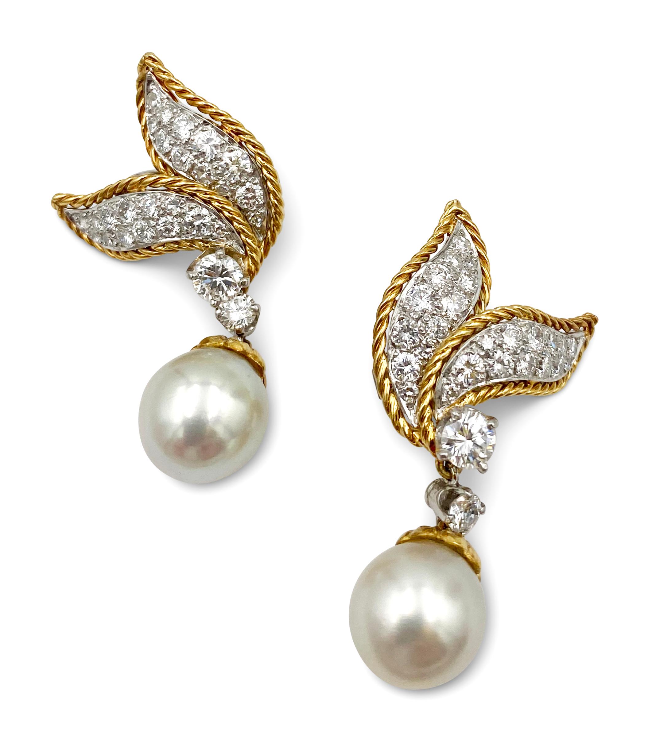 Vintage 1960s Van Cleef & Arpels diamond and pearl ear clips made in 18 karat yellow gold. The earrings feature a leaf motif set with round brilliant cut diamonds (E-G in color, VS clarity) of an estimated 2.0 carats set in platinum and completed