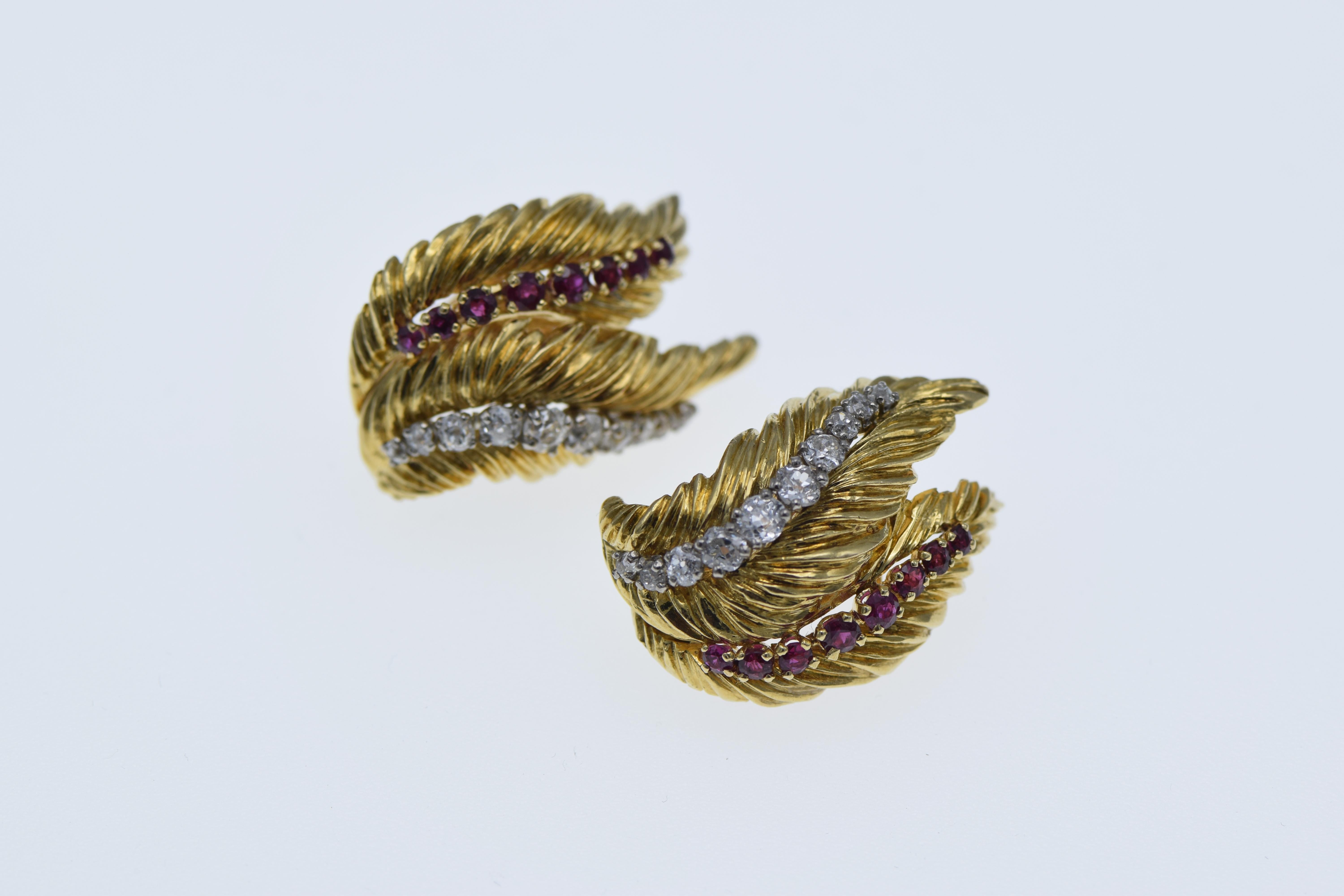 18 karat yellow gold ear clips featuring 20 old mine cut brilliant diamonds approximately 2.00 carats and 16 fine quality round brilliant cut rubies approximately 0.75 carats.  The earrings are stamped 