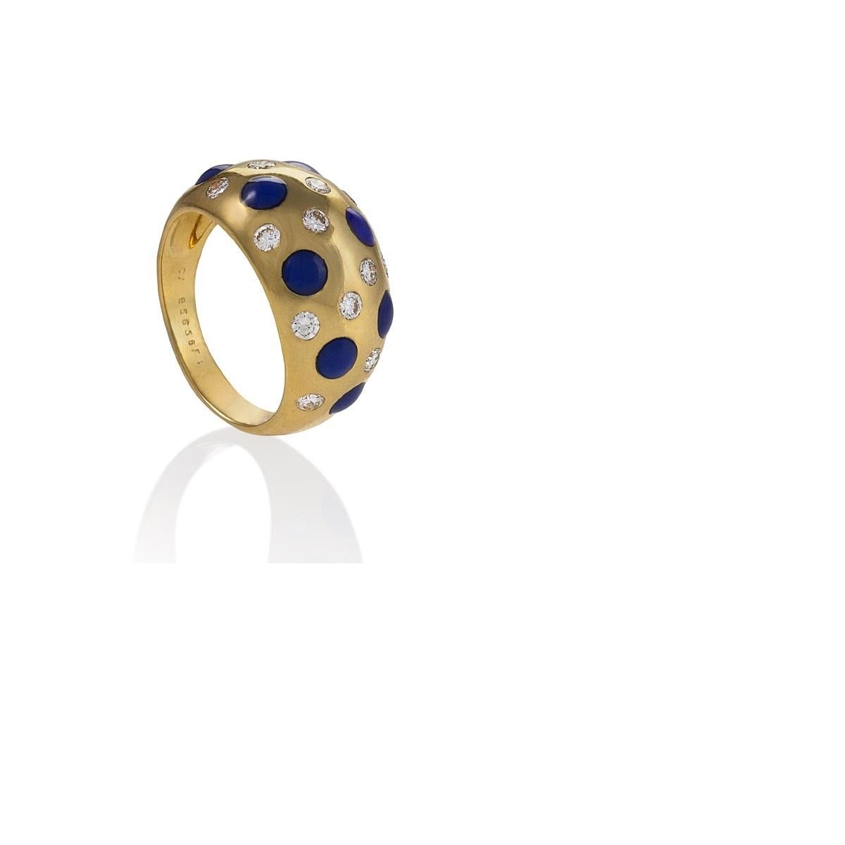 A French 18 karat gold ring with diamonds and sapphires by Van Cleef & Arpels. The is ring has 13 round brilliant cut diamonds with an approximate total weight of .65 carats, and 8 cabochon sapphires with an approximate total weight of .96 carats. 