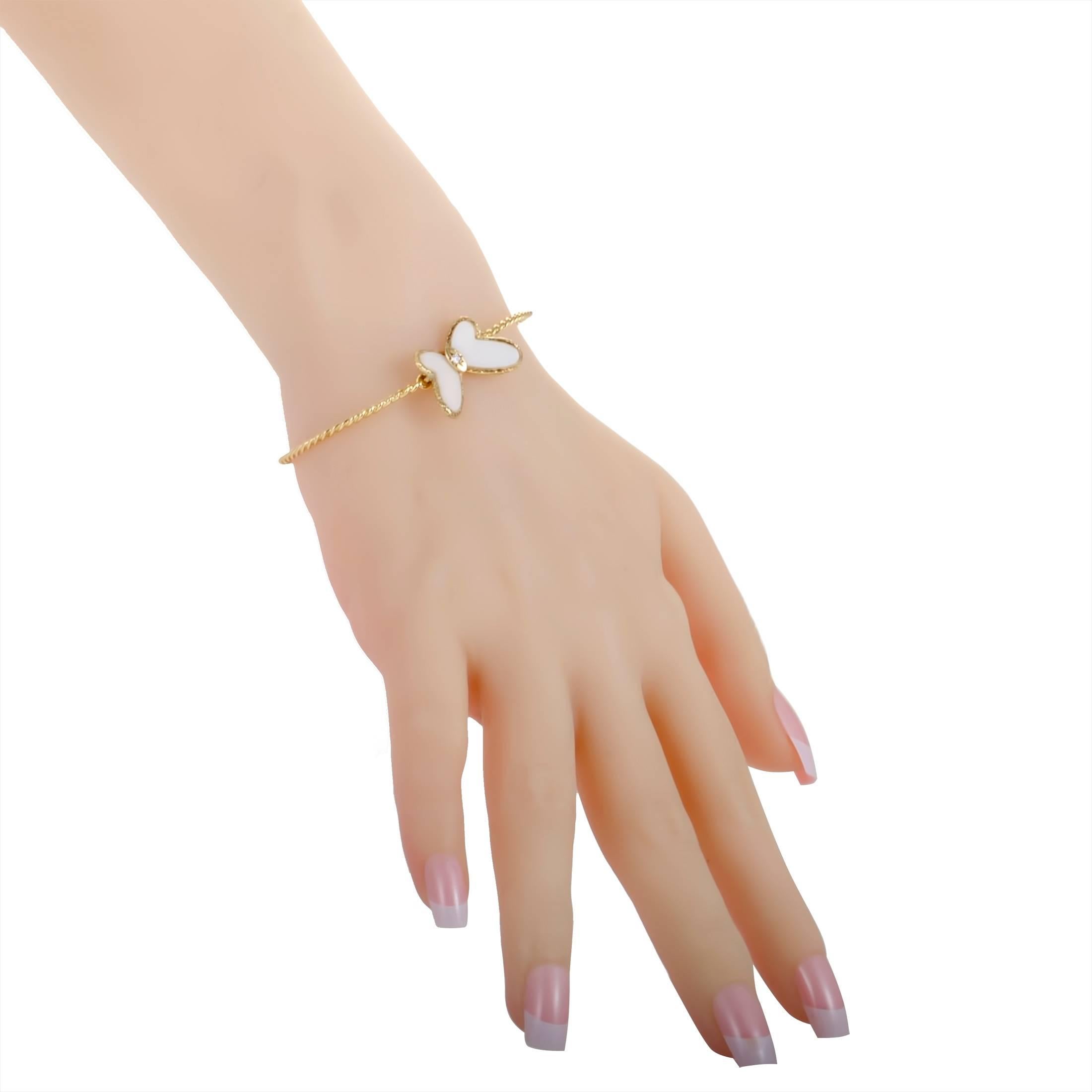 This stunning bracelet by Van Cleef & Arpels is bound to embellish any arm it is worn on! Beautifully designed in 18K yellow gold, the delicate bracelet has a butterfly accented with white coral wings and one sparkling diamond that enhances the