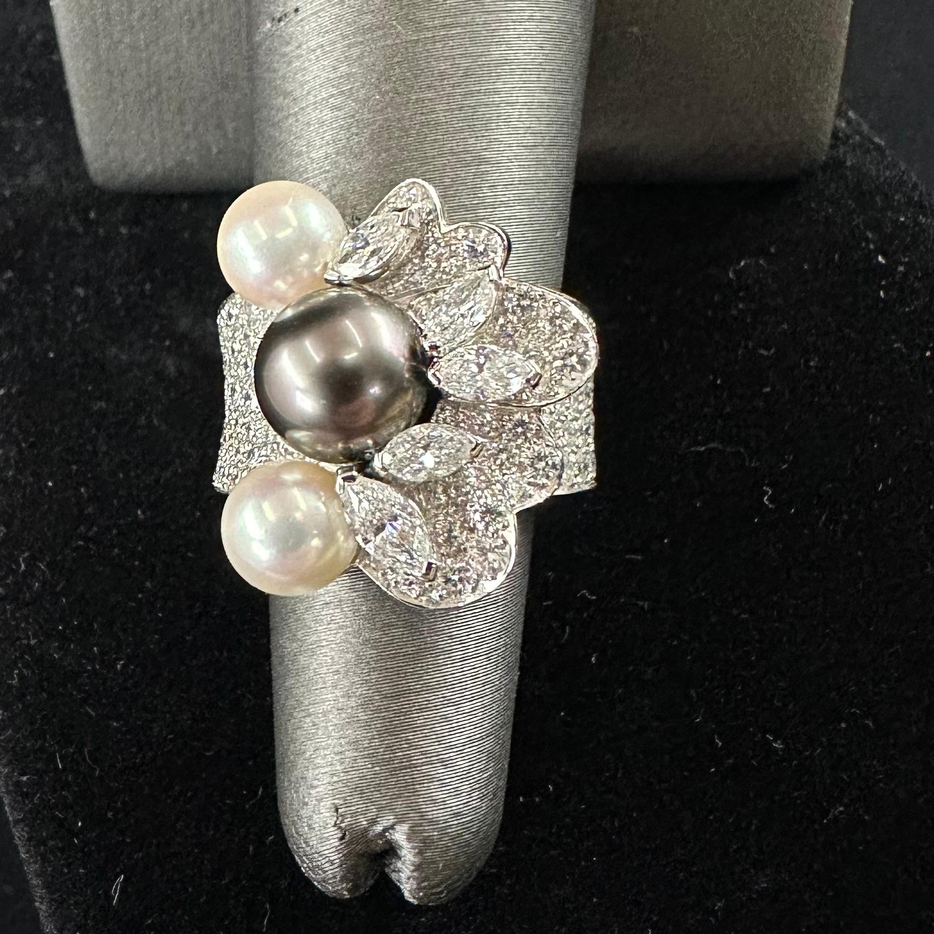 Van Cleef & Arpels
Three Akoya pearls, two cream color, and one black color pearl 8.5 mm and 6.5 mm Pearls. 
Ring size 51 or 5.5 US
Width at top of the ring 20 mm and  tapering down to 7mm. 
Estimated diamond weight 4.25 carats total comprised of