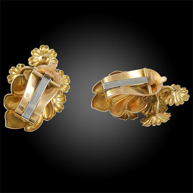 A pair of vintage Van Cleef & Arpels ear clips that date back to the 1970’s, each designed as a flower bouquet made of 18k yellow gold, each flower pistil set with a brilliant round diamond.

Van Cleef & Arpels France
Circa 1970’S