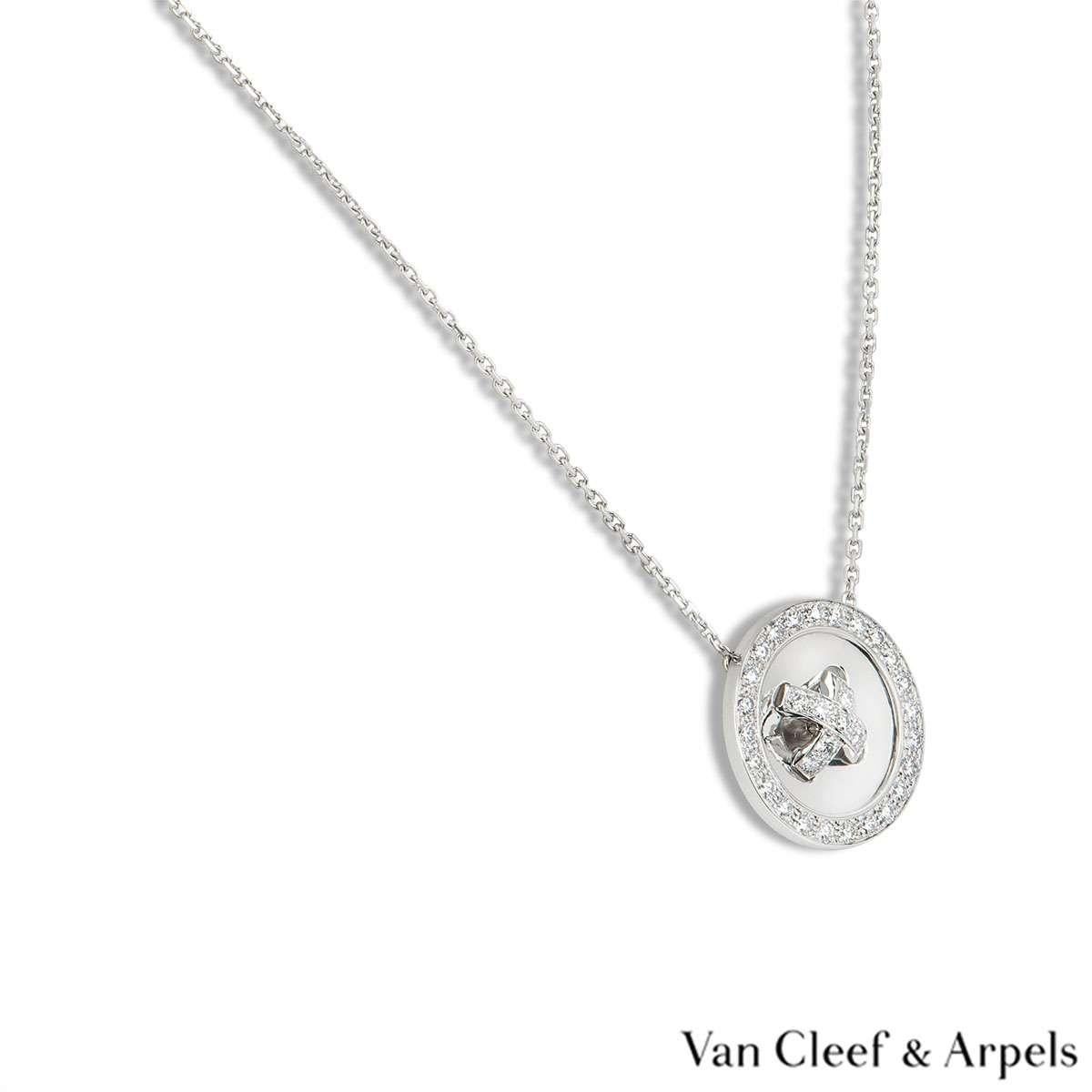 An 18 carat white gold diamond pendant by Van Cleef & Arpels. The pendant is a button motif set with round brilliant cut diamonds in the centre and around the outer edge. There are 33 diamonds with a total weight of approximately 1.00 carats. The