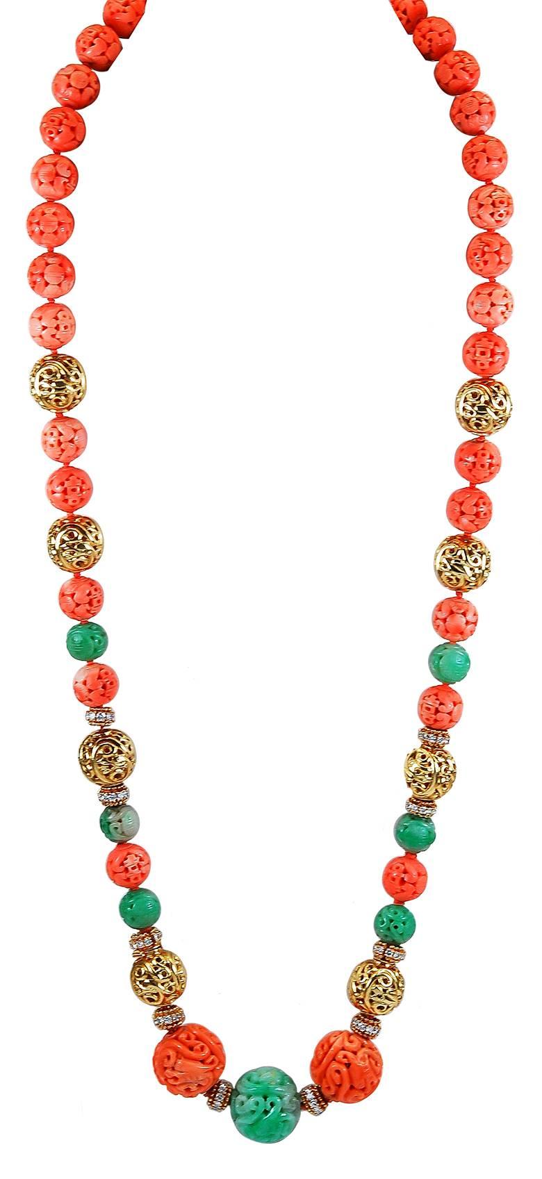 A vibrant piece centering 2 carved coral beads approx. 22.0 mm., and one carved jade bead approx. 23.0 mm., completed by 33 surrounding carved coral beads approximately 13.6 to 12.6 mm. and 6 carved jade beads approx. 12.8 mm., the carvings of