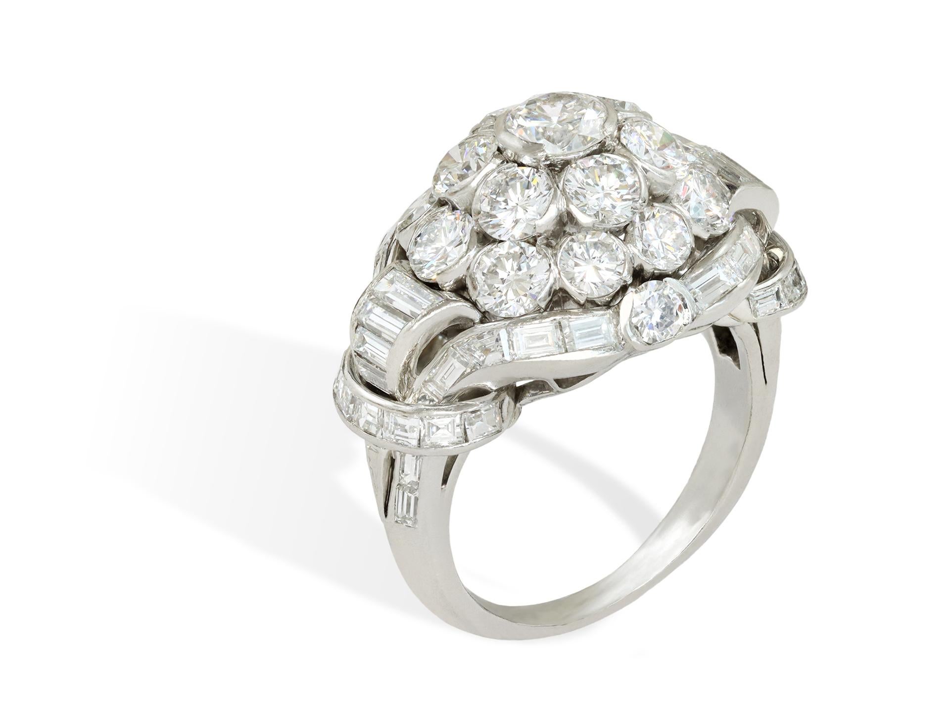 Van Cleef & Arpels diamond cluster ring. Set to centre with a round brilliant cut diamond in an open back part-rubover setting with an approximate weight of 0.50 carats, further set with eighteen round brilliant cut diamonds in open back