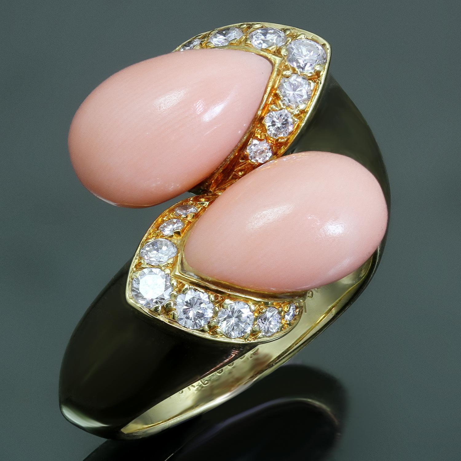 This beautiful vintage Van Cleef & Arpels ring is crafted in 18k yellow gold and set with 7.0mm x 11.0mm corals and round brilliant E-F VVS2-VS1 diamonds weighing an estimated 0.35 carats. Made in France circa 1970s. Measurements: 0.62