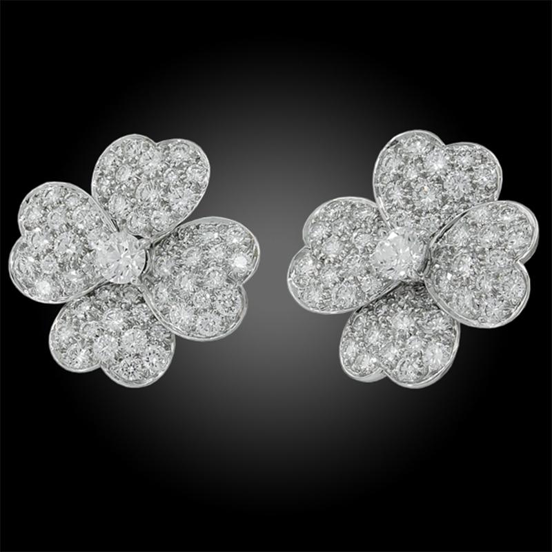 VAN CLEEF & ARPELS Cosmos Diamond Pave Earrings in 18k White Gold.

A perfect combination of sophistication, finesse, and poise, this set of on-the-ear clips feature a floral motif emblematic of the Van Cleef & Arpels repertoire since inception. In
