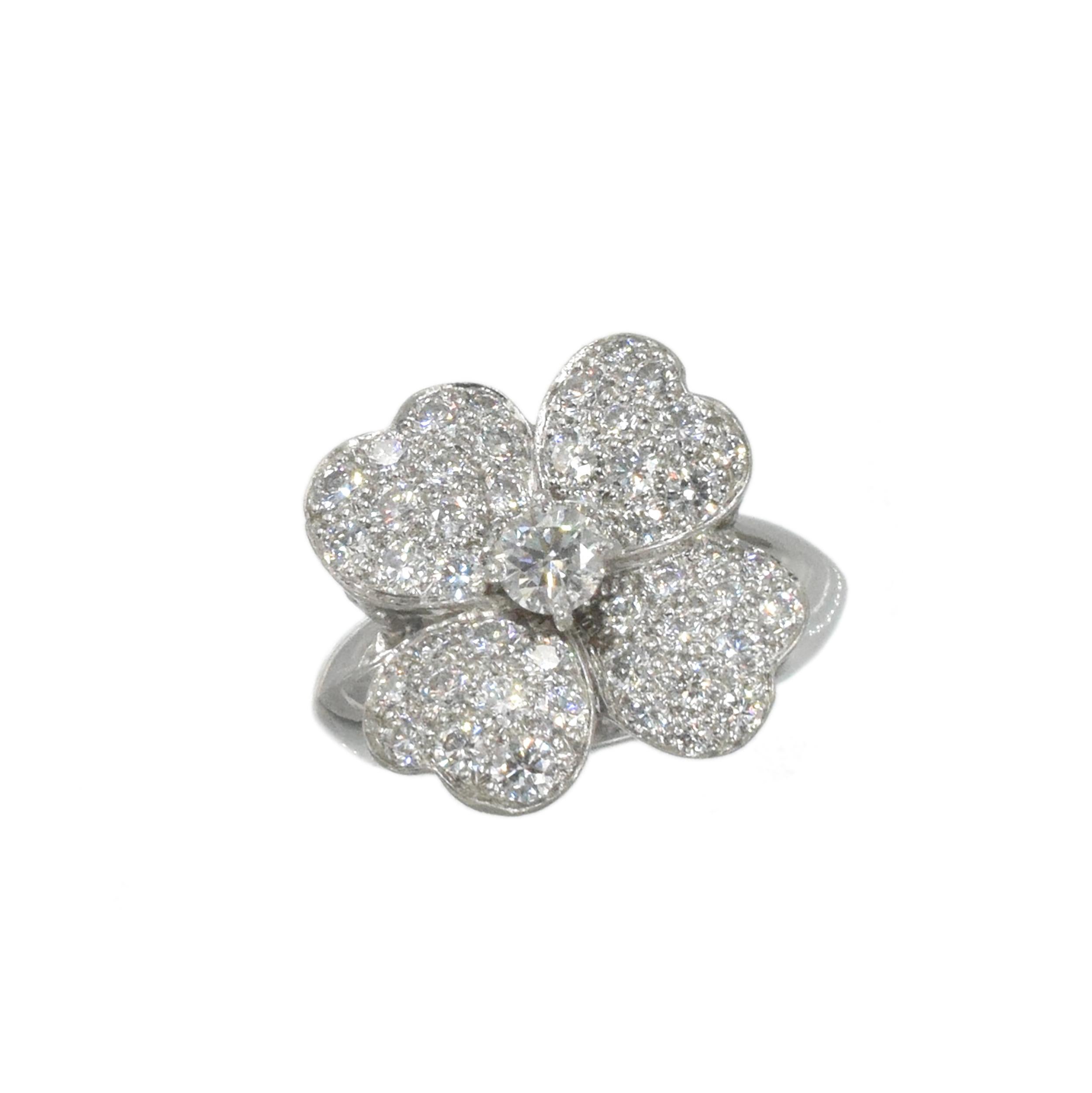 Van Cleef & Arpels Diamond 'Cosmos' Ring. Medium size.
This  ring has a flower motif with round
diamonds weighing approximately 1.50 carats including center approximate 0.25 carat  all
set in 18k white gold.  No. BL270398, 750, 50. Finger Size: 50