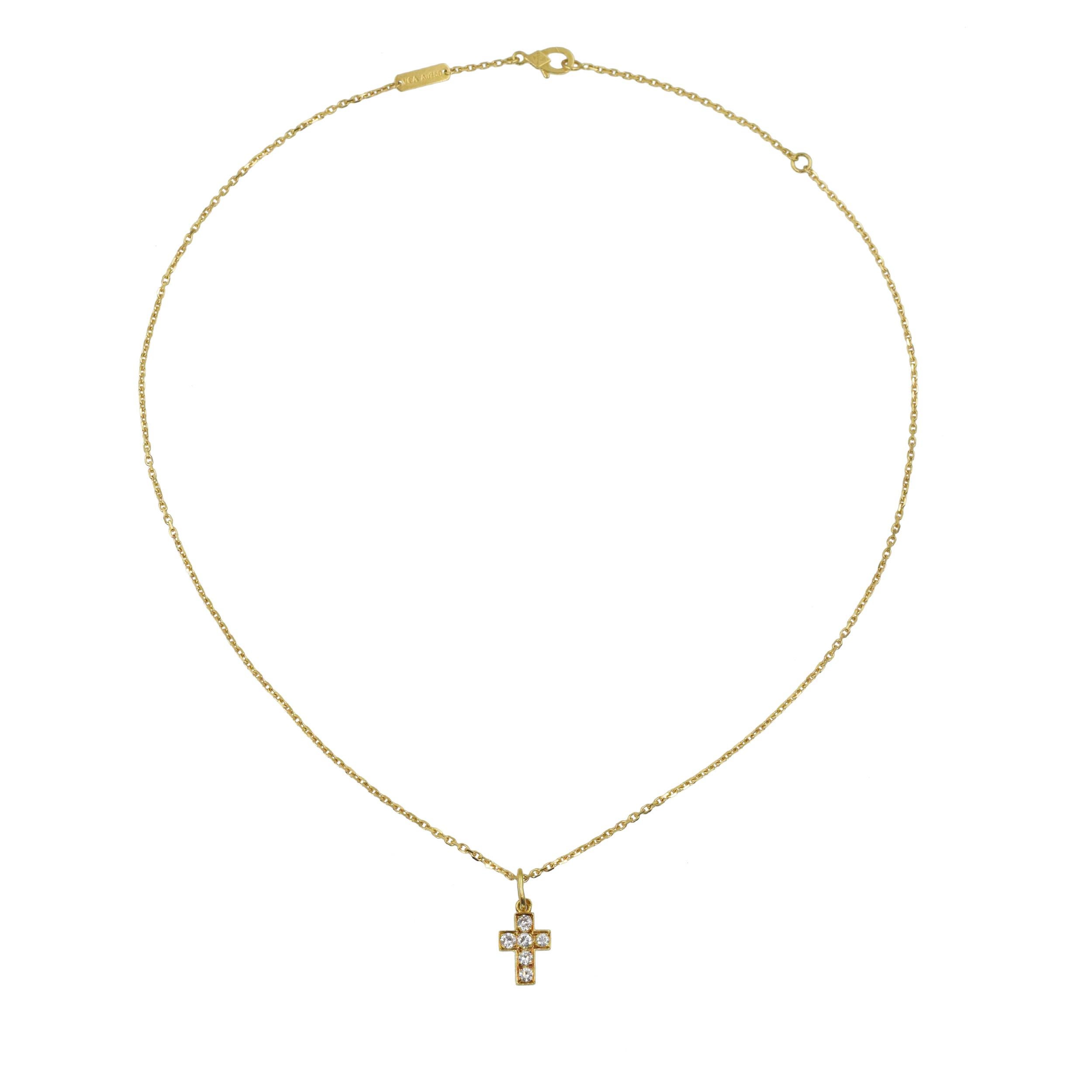 Van Cleef & Arpels diamond cross pendant necklace in 18k yellow gold. The a small cross, set with 5 round brilliant cut diamonds with total weight of approximately 0.25ct, color F-G, clarity VS. Measurements: 13mm by 8mm. Inscribed: VCA, 18k, C41