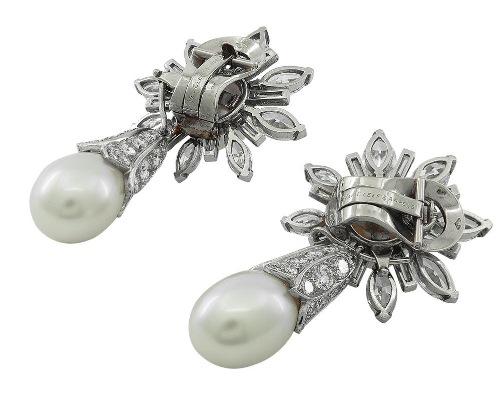 A pair of notable mid-century diamond and pearl earrings by Van Cleef & Arpels. The 1950s brought a return to a classic diamond look for the Maison, as well as the concept of convertibility for a variety of wear. Each surmount features a gorgeous