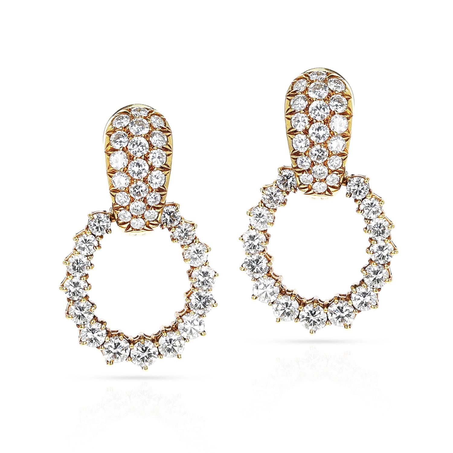 A pair of Van Cleef & Arpels Diamond Dangling Hoop Earrings made in 18 Karat Gold. The length of the earring is 1.25.