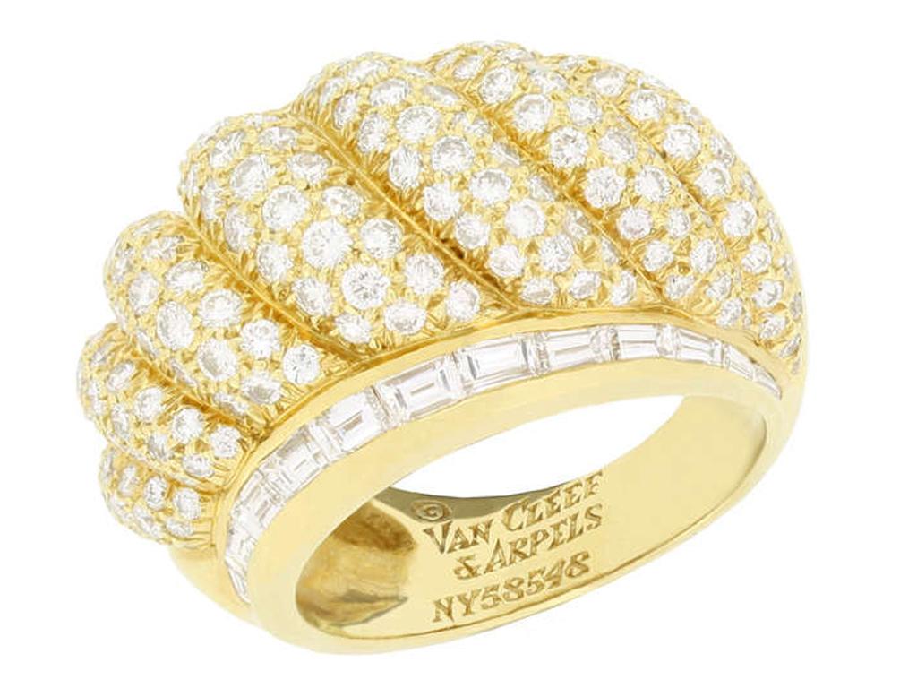 Van Cleef & Arpels vintage diamond dress ring. Set with one hundred and ninety six round brilliant cut diamonds in open back grain settings with a combined weight of 3.38 carats, bordered by two horizontal channel set graduated rows of rectangular