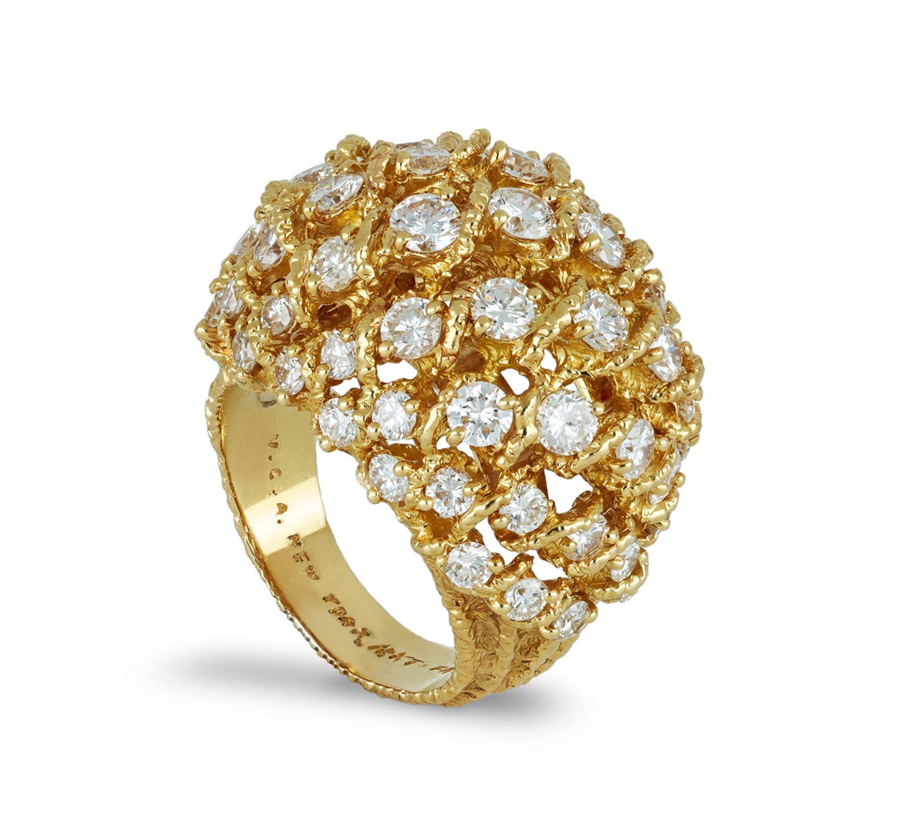 Van Cleef & Arpels diamond dress ring. Set with fifty seven round brilliant cut diamonds in open back claw settings with a combined weight of 2.75 carats, to an impressive bombé design with textured gold-work throughout, featuring curving rows,