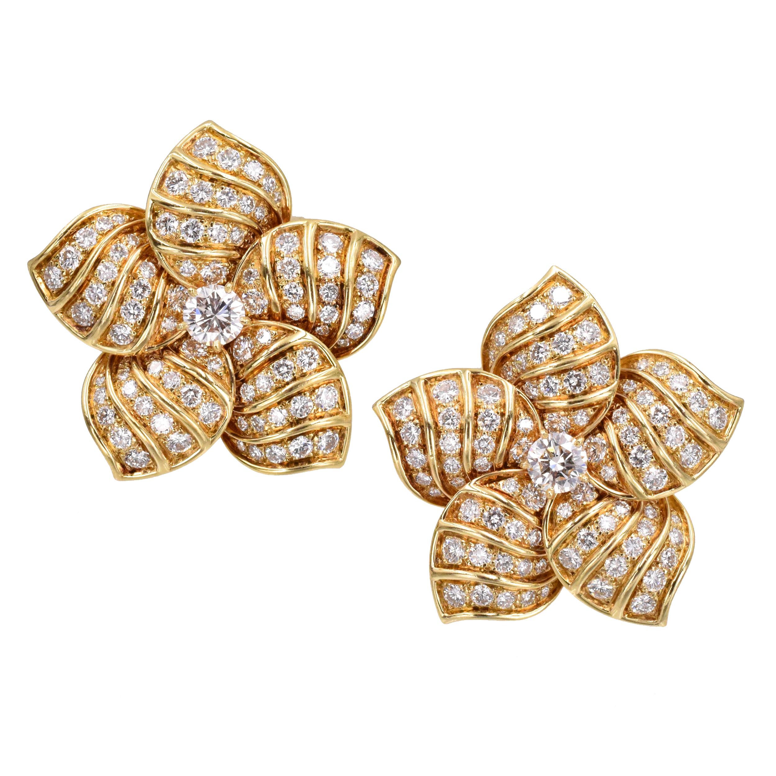 Classic Van Cleef and Arpels clip on earrings!!!!

 Designed as flower-heads with round diamonds with large center diamonds
 Weight of the diamonds is  approximately 4.05 carats, 
 Signed VCA, Made in France,
 
 Numbered NY xxxxx, with French assay