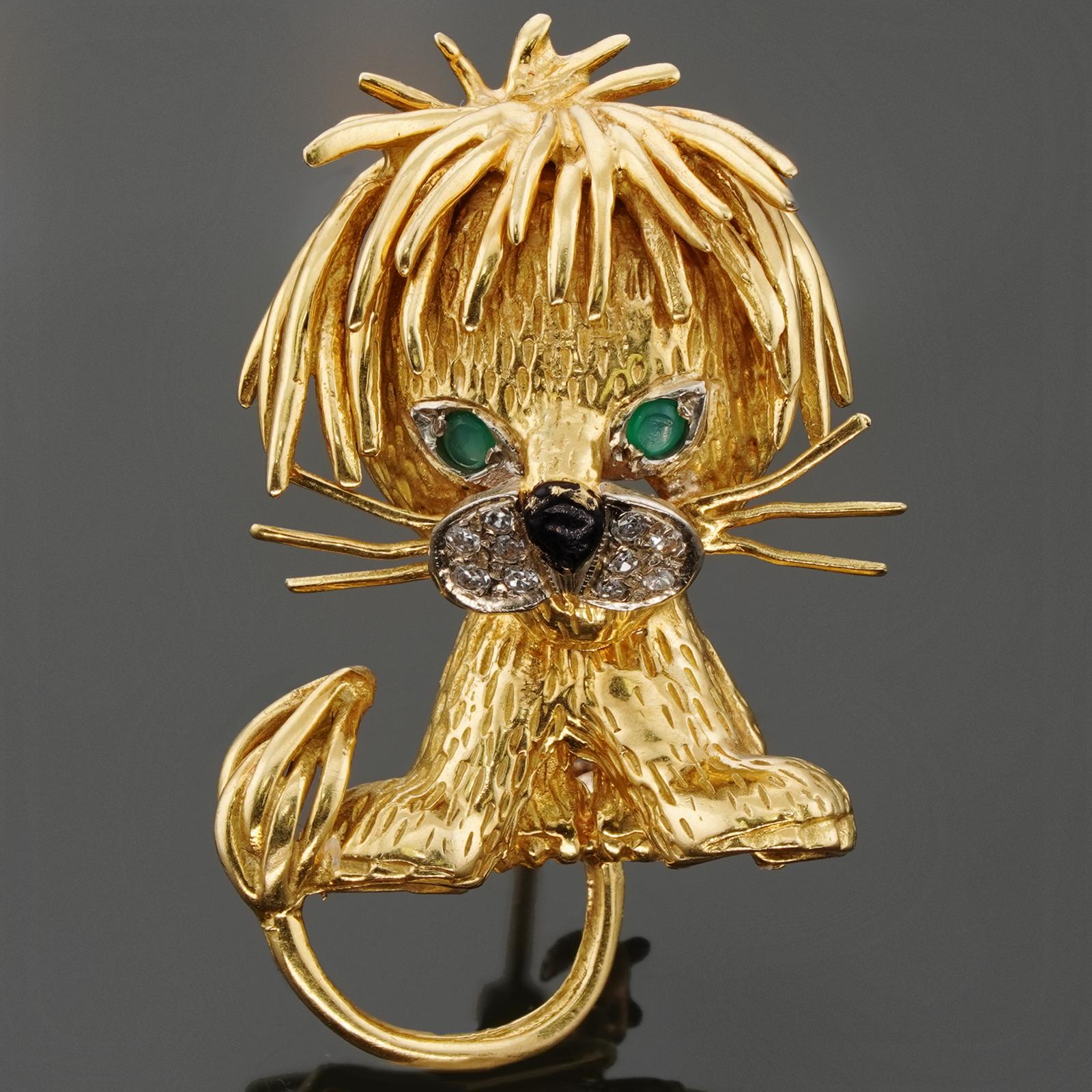 This iconic Van Cleef & Arpels brooch features a fabulous lion design crafted in 18k yellow gold and accented with brilliant-cut diamonds, green emerald eyes, and a black enamel nose. Made in France circa 1980s. Measurements: 0.78